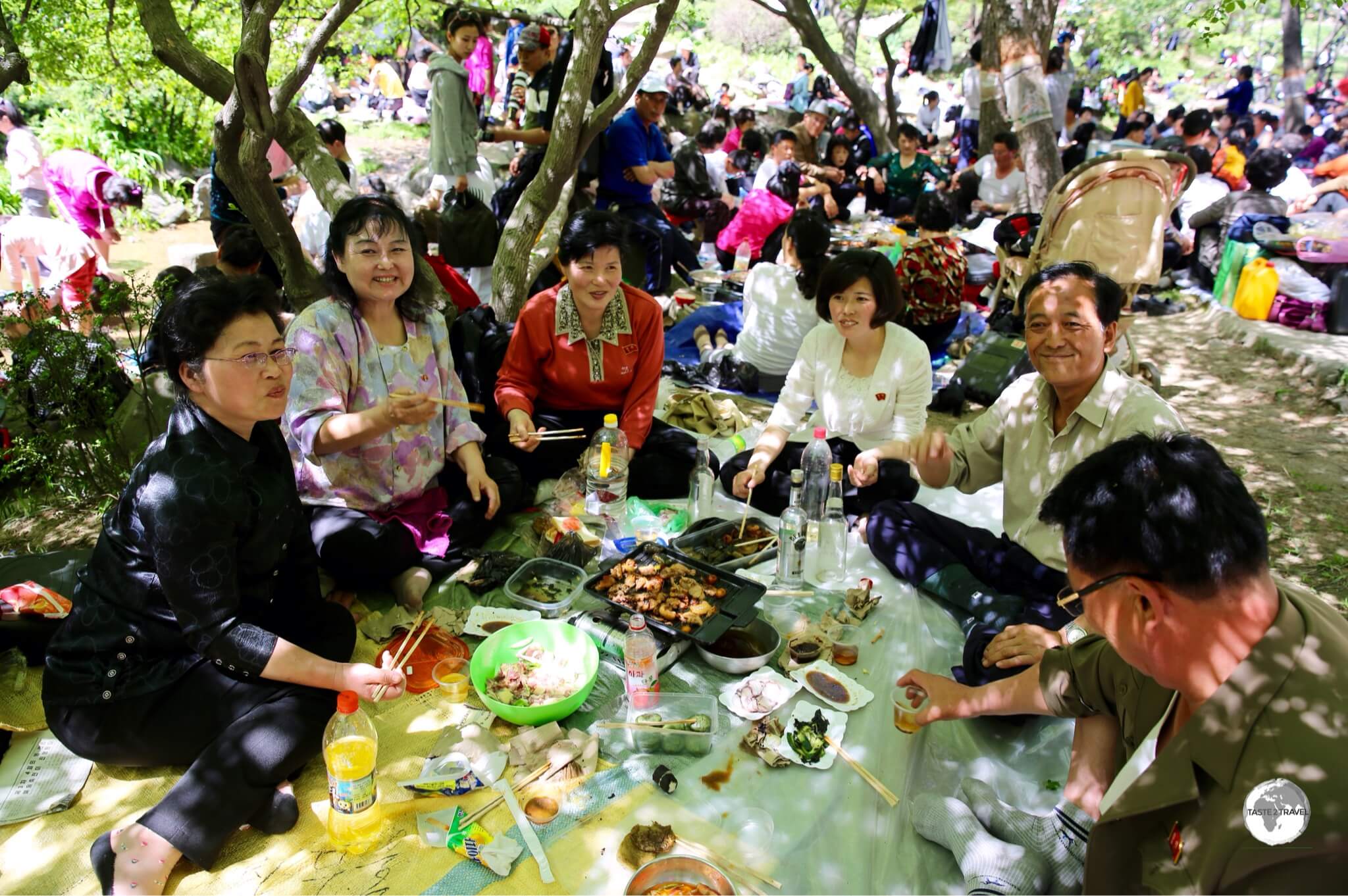 A group of friendly and welcoming North Koreans, enjoying a picnic lunch at Moran hill during the May day public holiday.