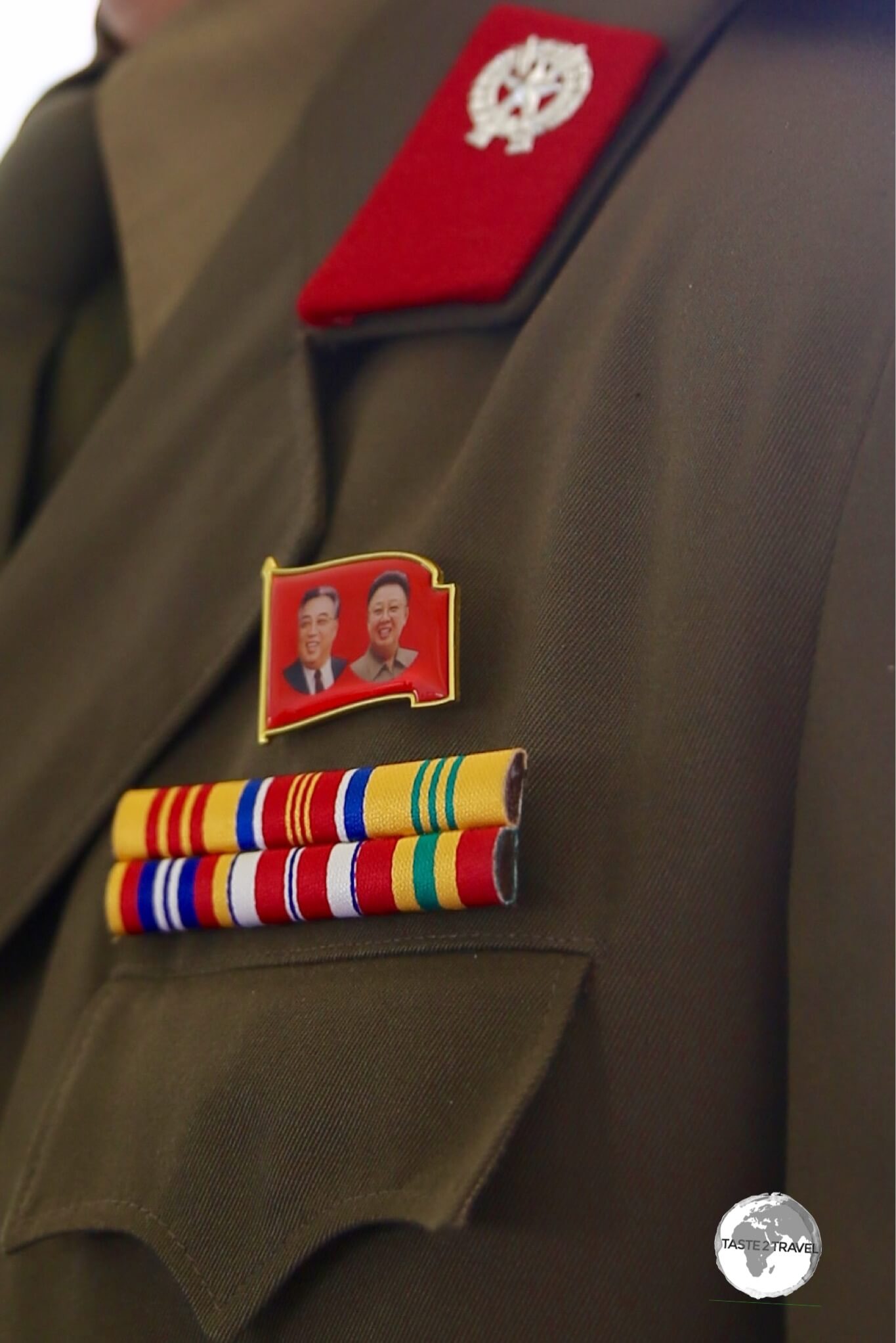 The party badge, which features images of Kim Il-sung and Kim Jong-il, must be worn by North Korean adults at all times. 