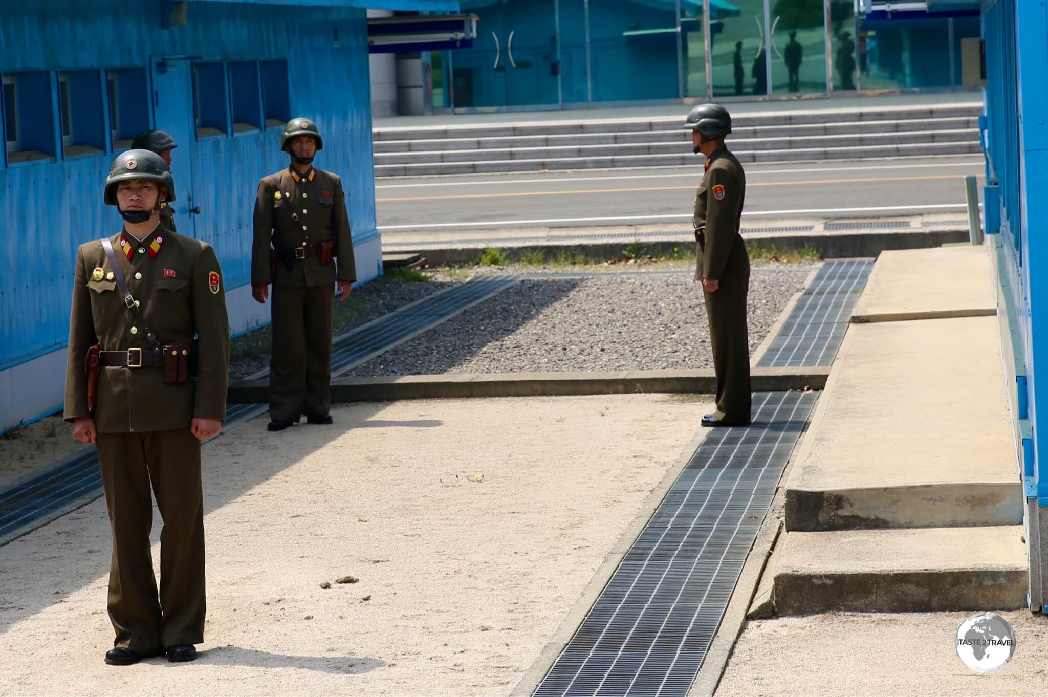 The concrete strip running between the huts marks the border between North and South Korea.