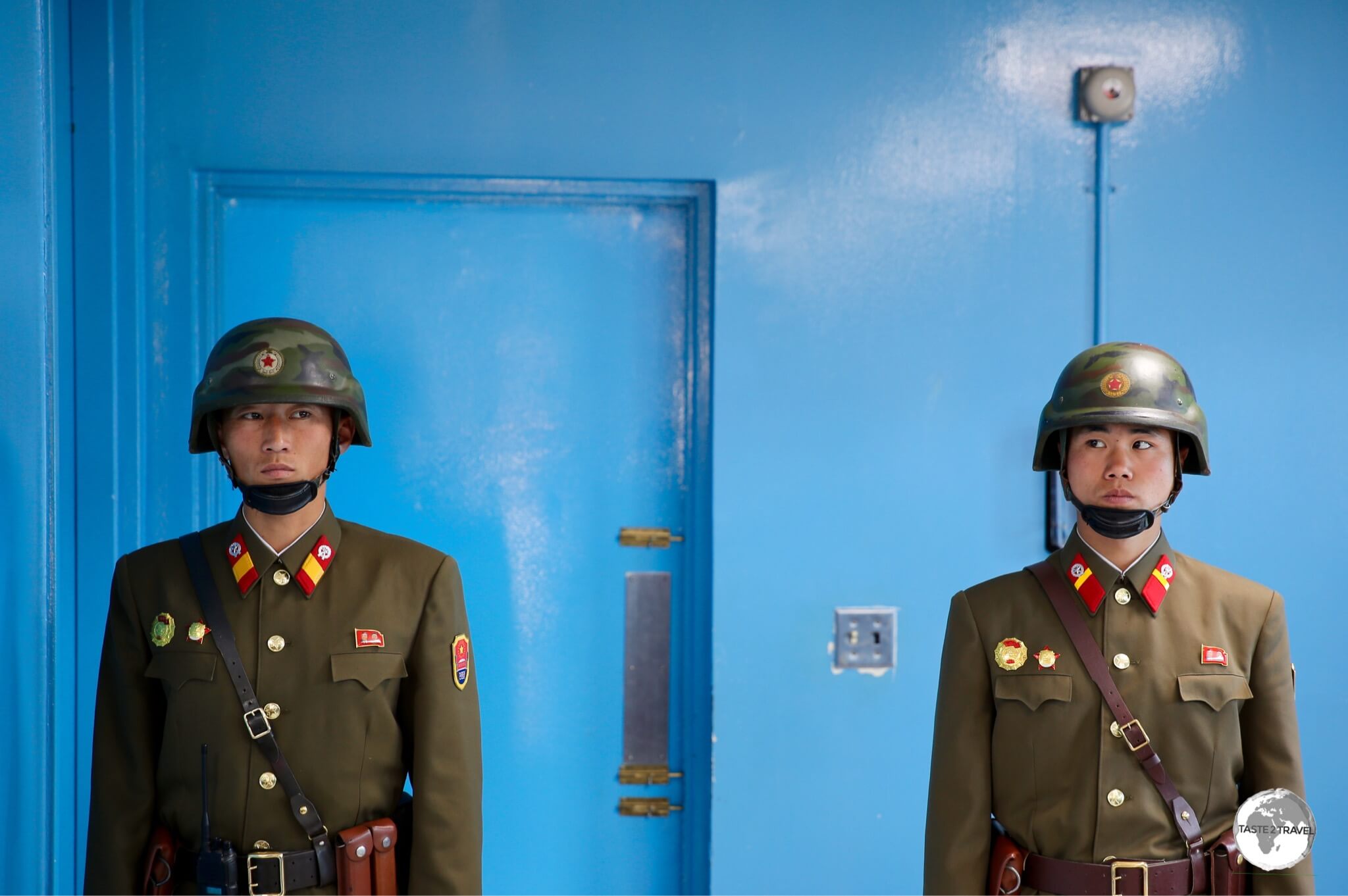 Guarded by two North Korean soldiers, the blue door is the exit to the South Korean side of the JSA.