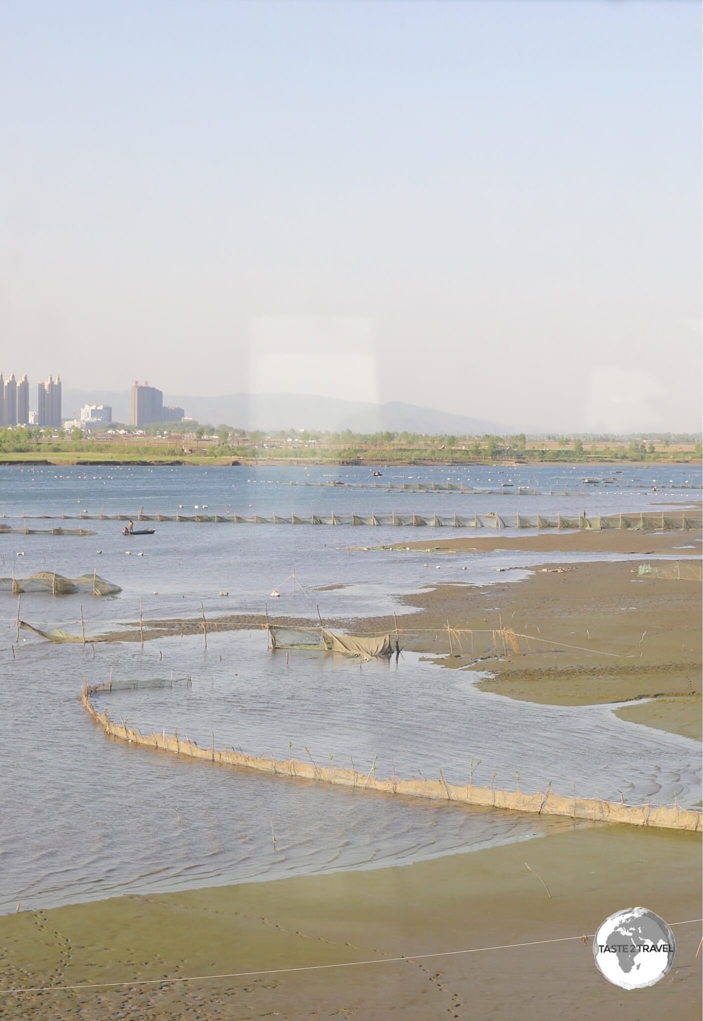 Our first view of North Korea – the banks of the Yalu river with the Chinese city of Dandong in the background.