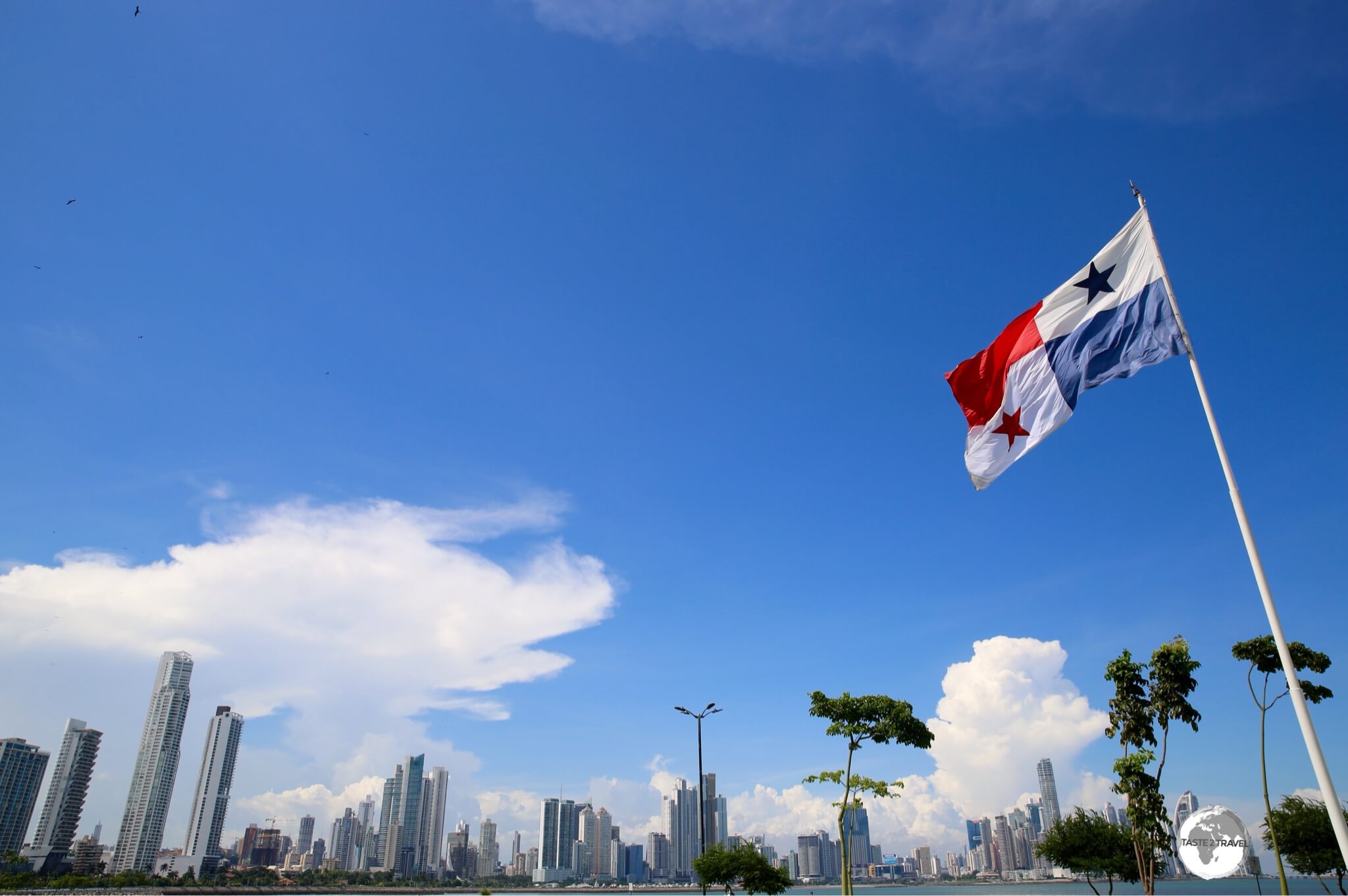 The Panama flag and the modern skyline of Panama City, a thriving metropolis.