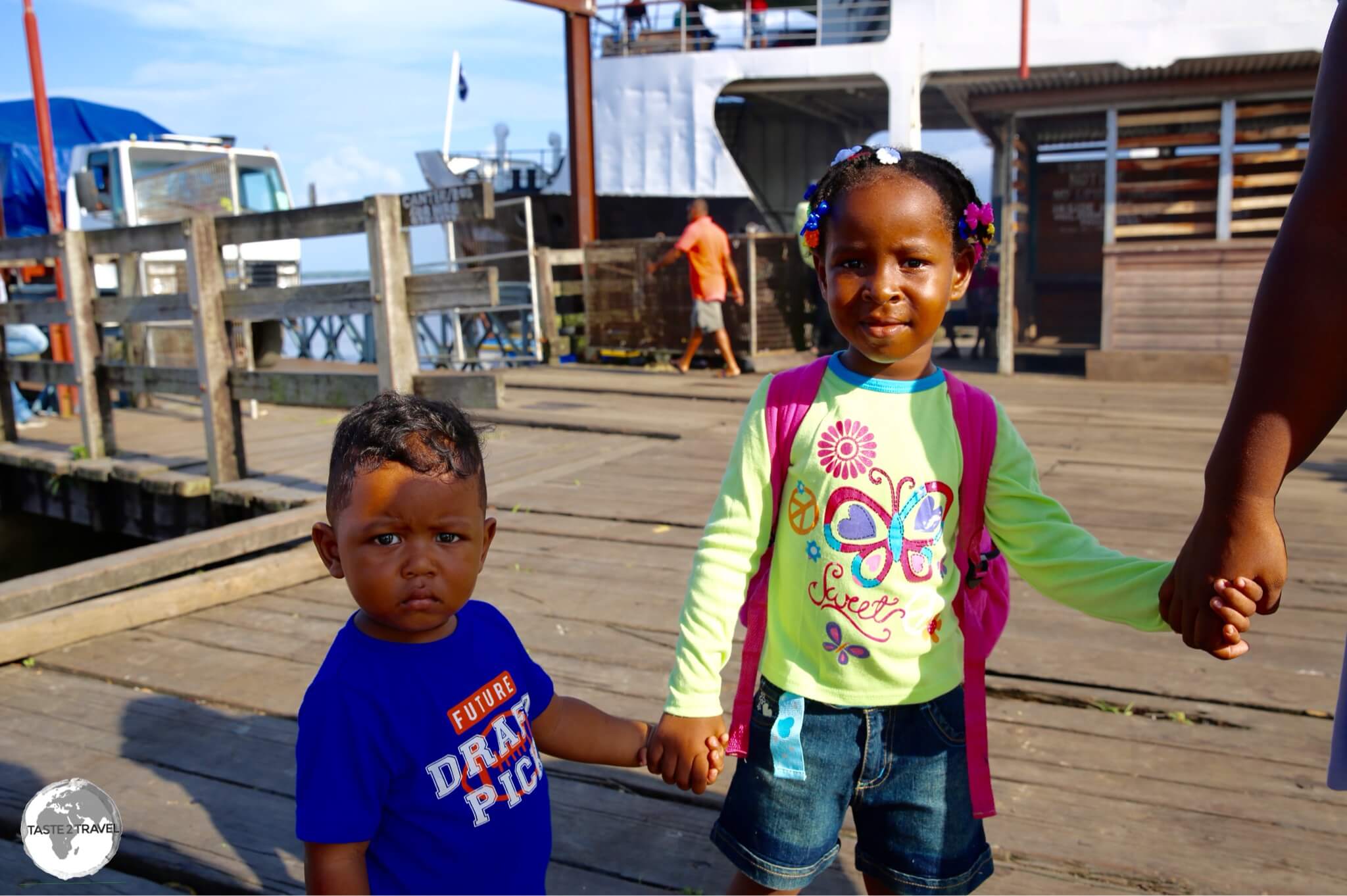 A family at Parika port waiting for their boat.