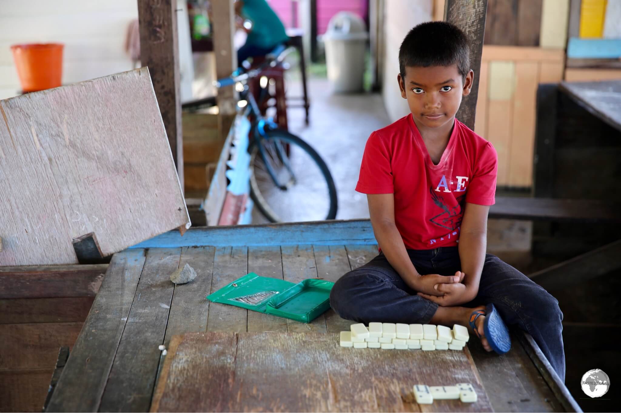 Young boy playing dominoes at Charity dock.