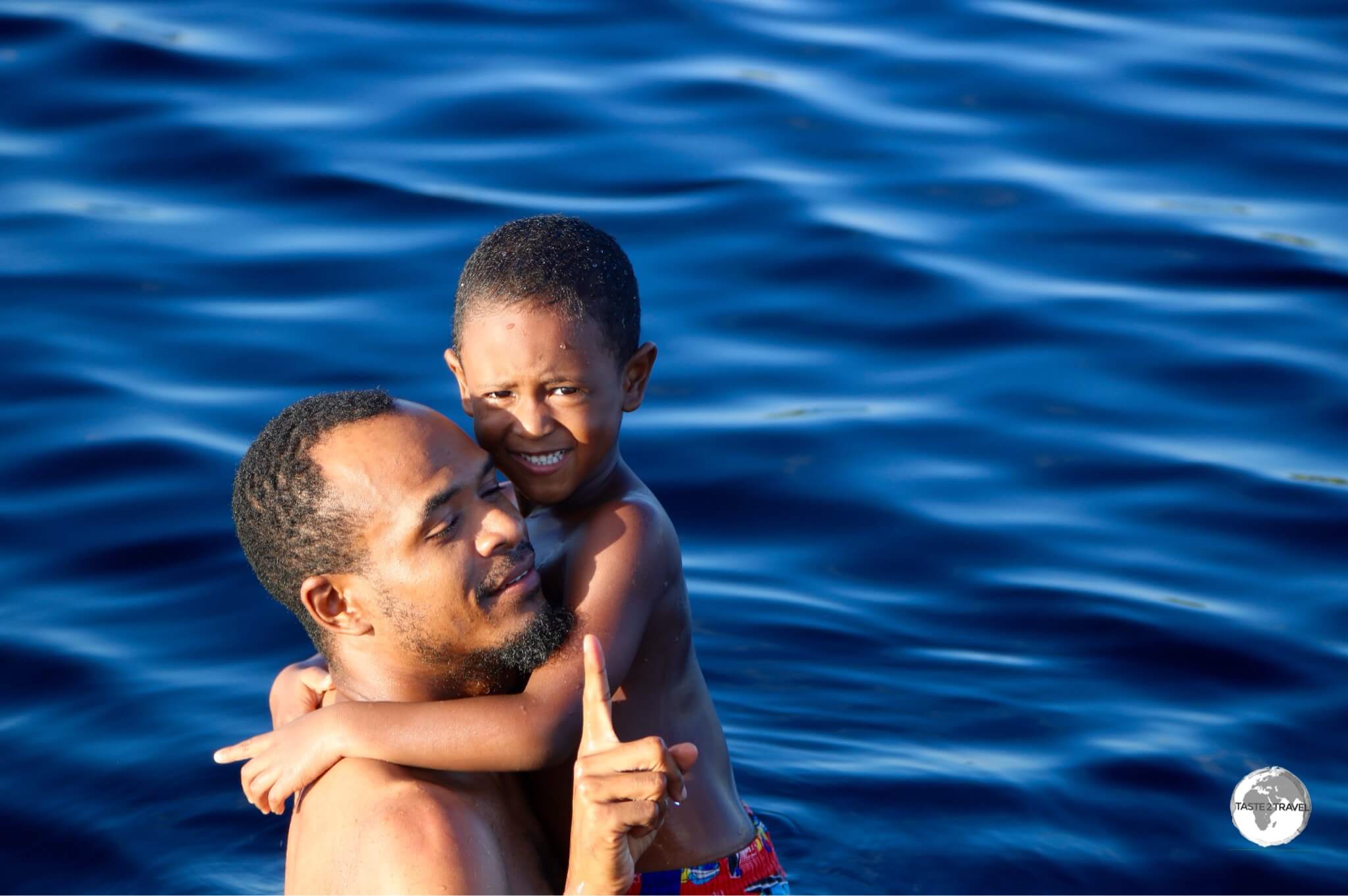 Father and son enjoying a swim in the black waters of Lake Capoey.