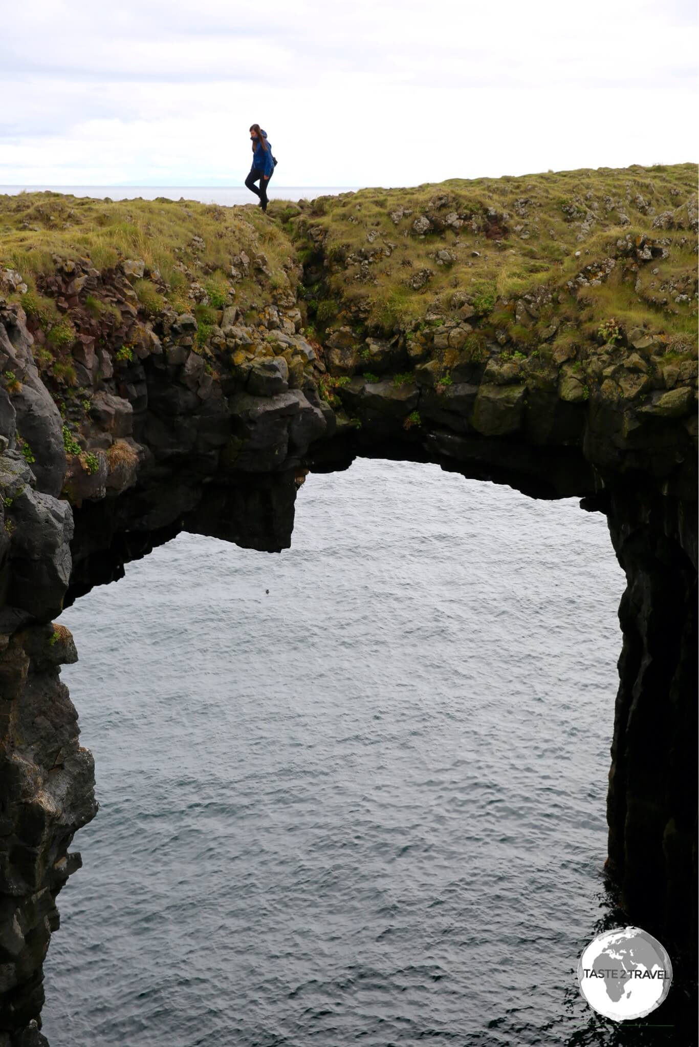 A natural bridge over a basalt ravine at Arnarstapi.