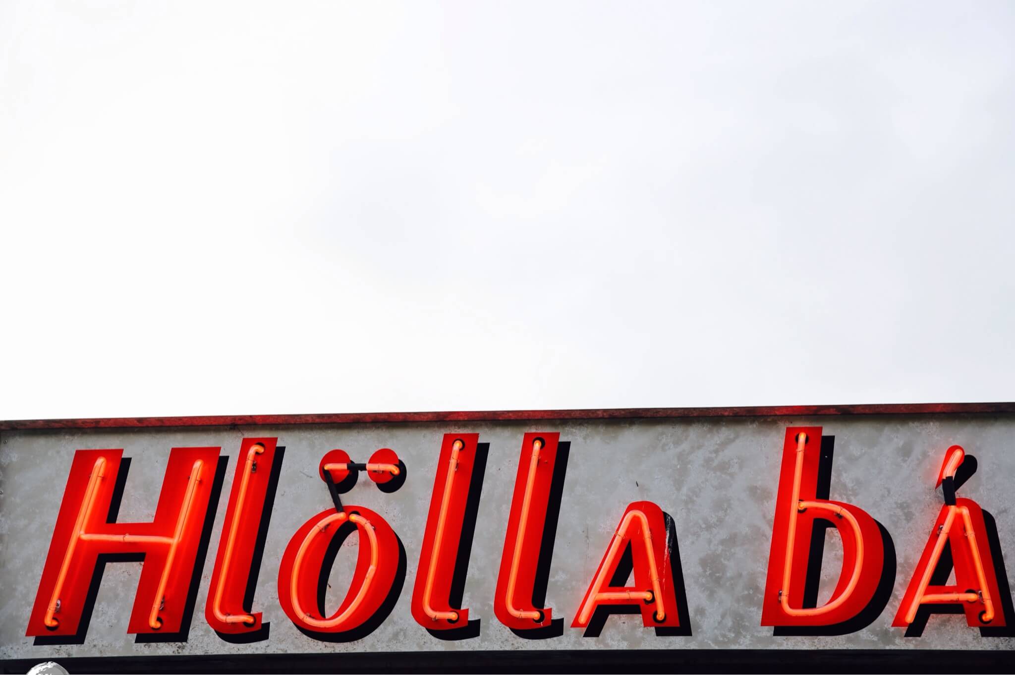 Neon signage against a grey sky in downtown Reykjavik.