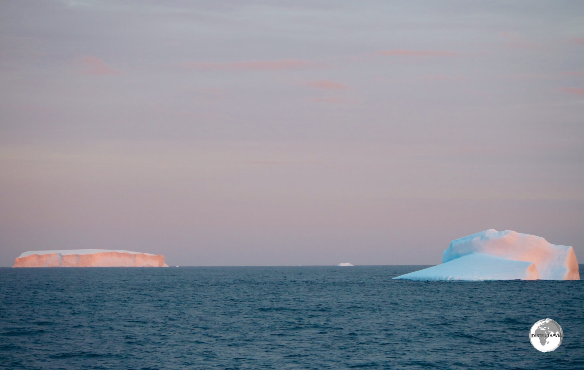 Icebergs glow in the setting Antarctic sun.