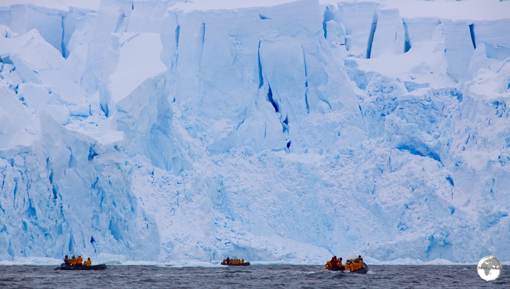 Our Zodiacs provide a sense of scale for the imposing glaciers of Andvord bay.