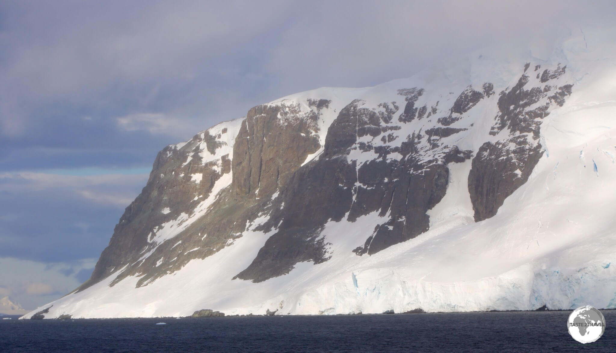 A view of the towering peaks of Graham Land from the narrow Lemaire channel. 