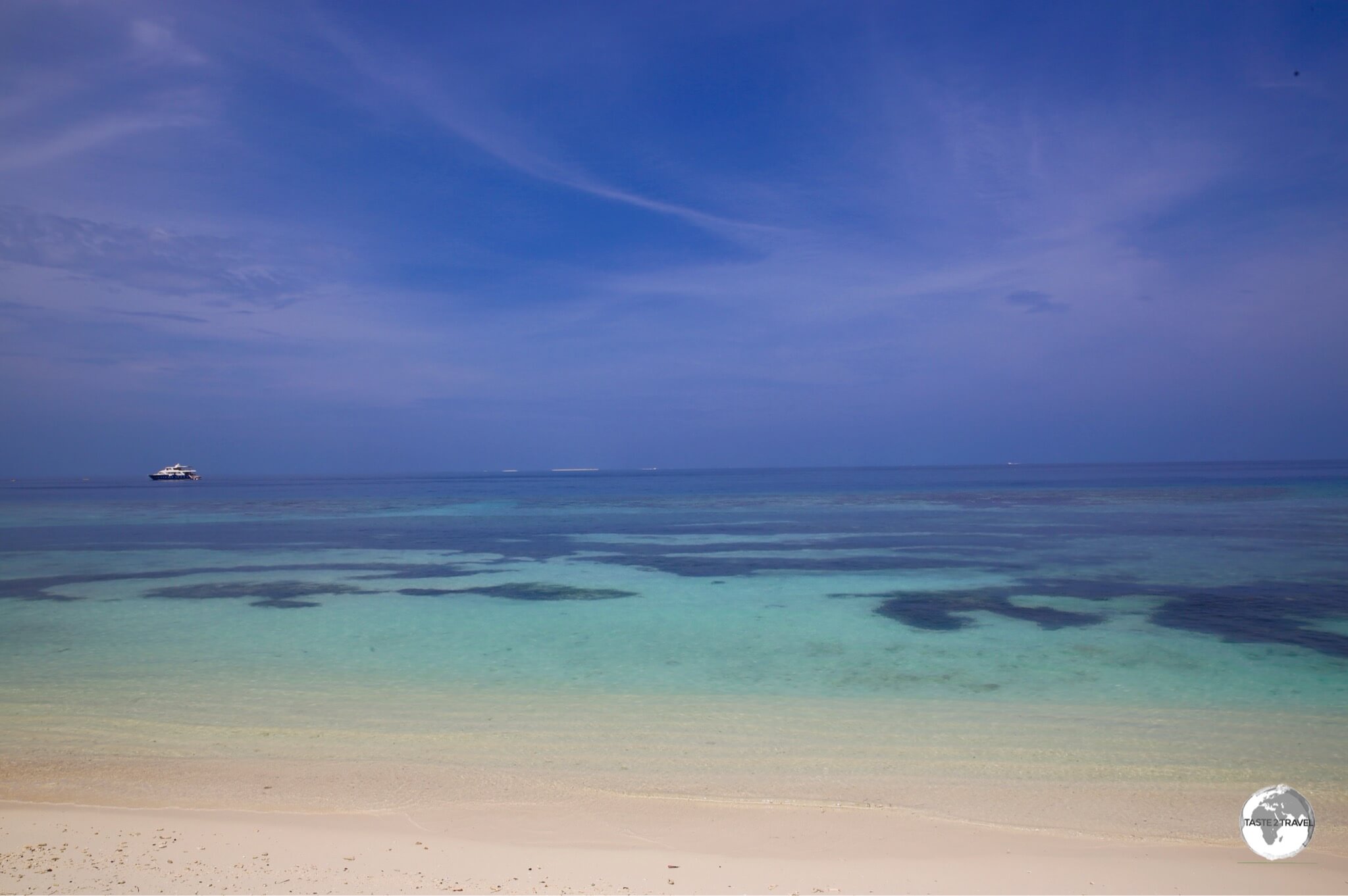 The low-lying islands of the Maldives, such as Maafushi Island, feature white sandy beaches with fringing coral reefs.