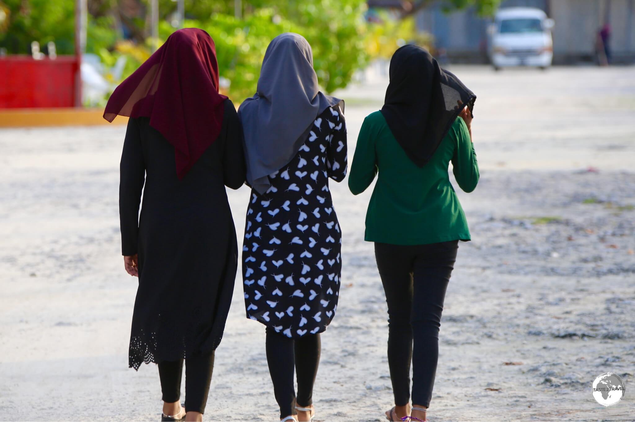 Covered girls on Maafushi Island, where rules require any tourist wearing a bikini on the beach to be covered prior to leaving the beach.