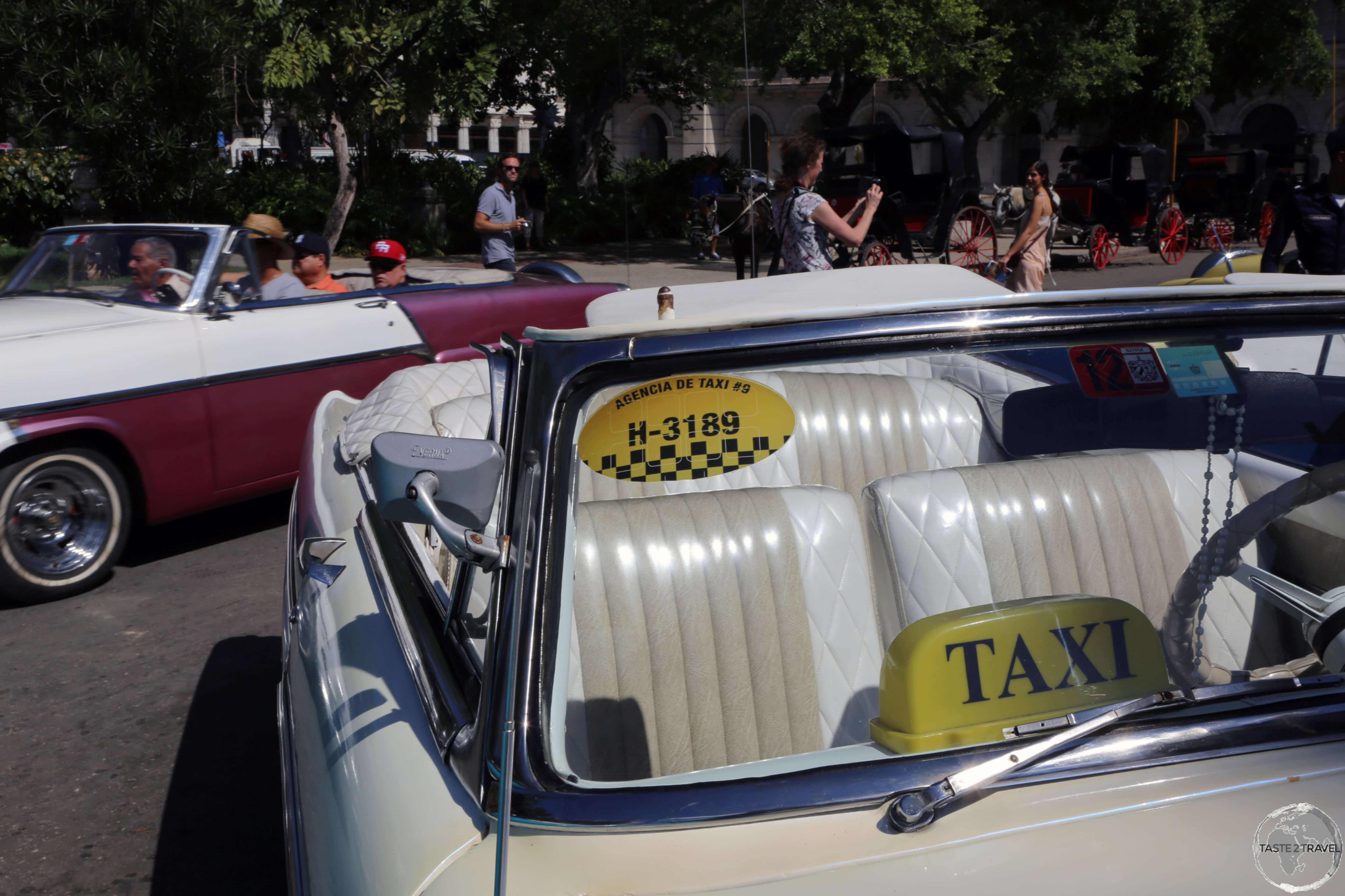 Beautifully maintained American classic car taxis at Parque Central in Havana old town.