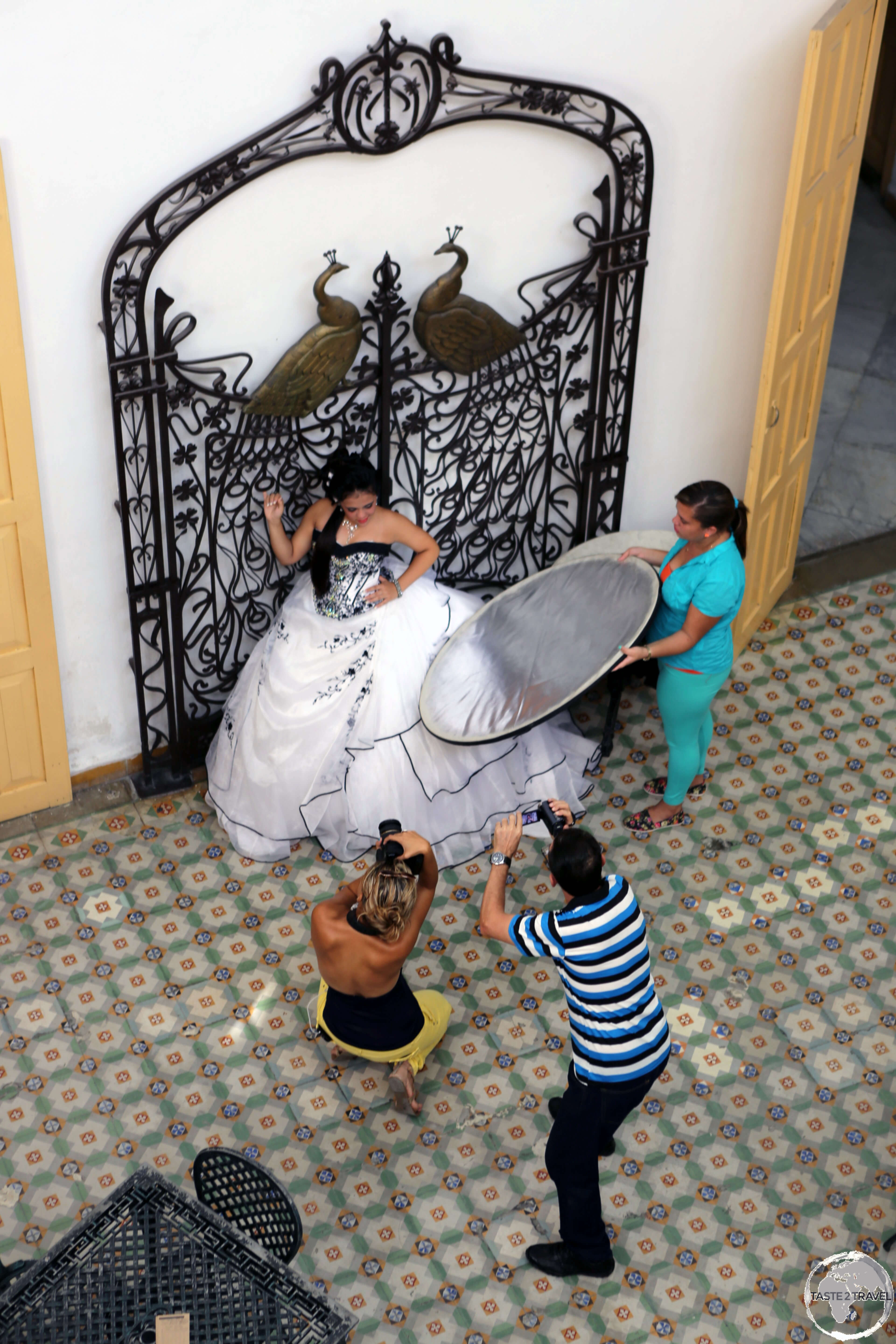 A bride being photographed inside the Museo Provincial in Cienfuegos.