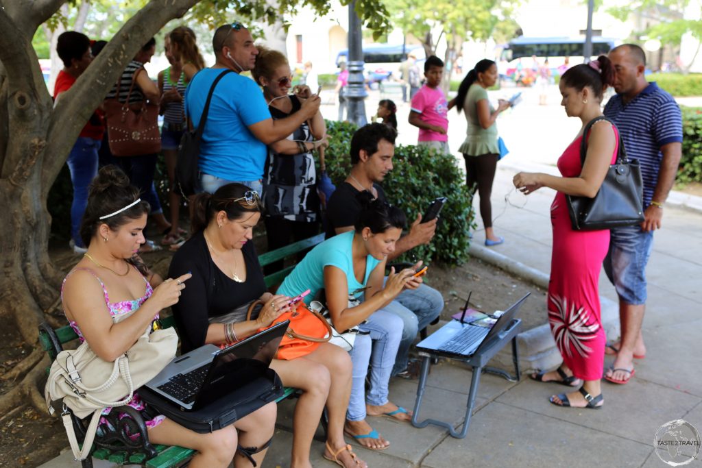 Internet surfing in the main square of Cienfuegos.