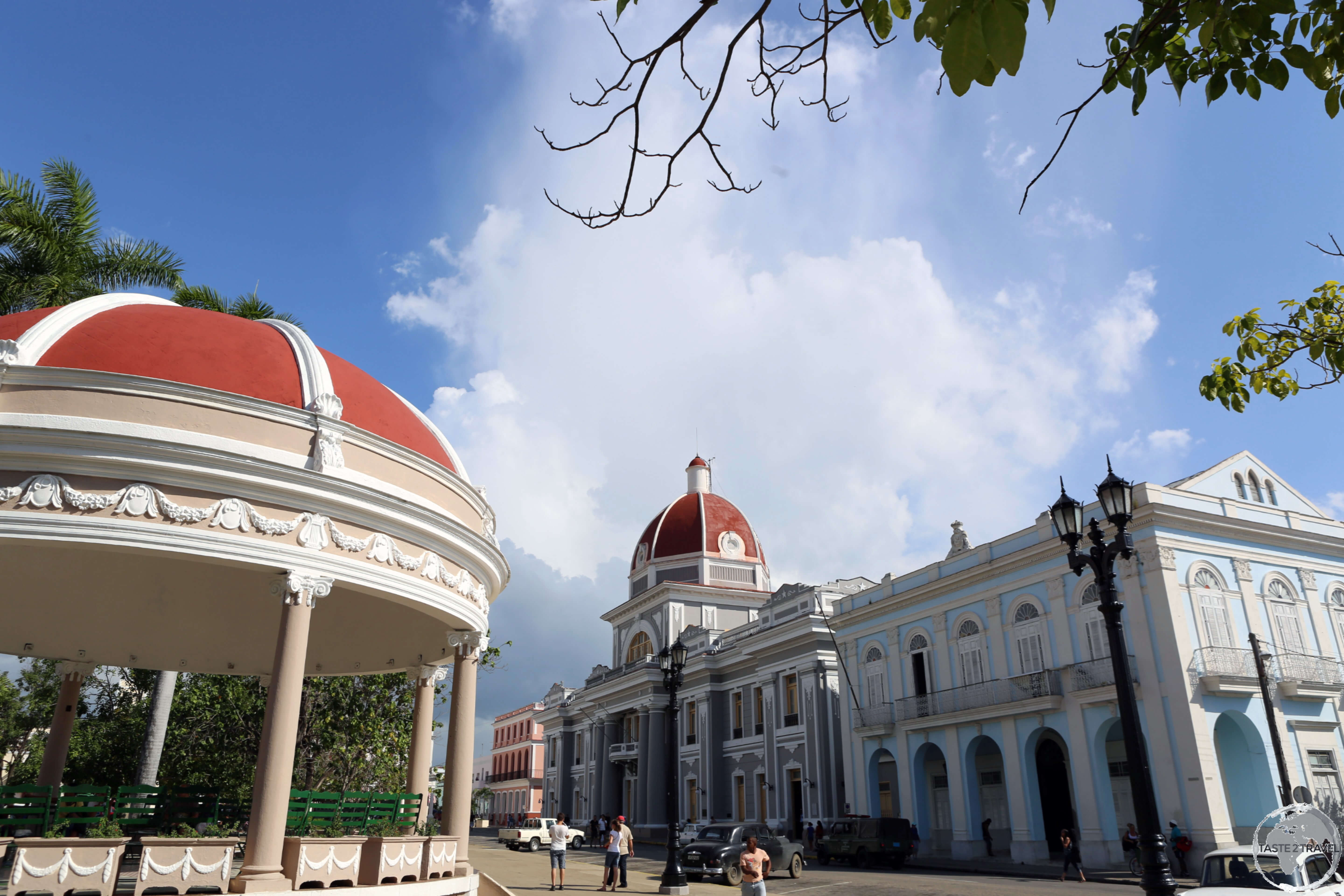 A view from <i>Plaza José Martí</i>, the heart of Cienfuegos, with the red dome of the imposing <i>Palacio de Gobierno</i> (home to the <i>Museo Provincial</i>) in the background.