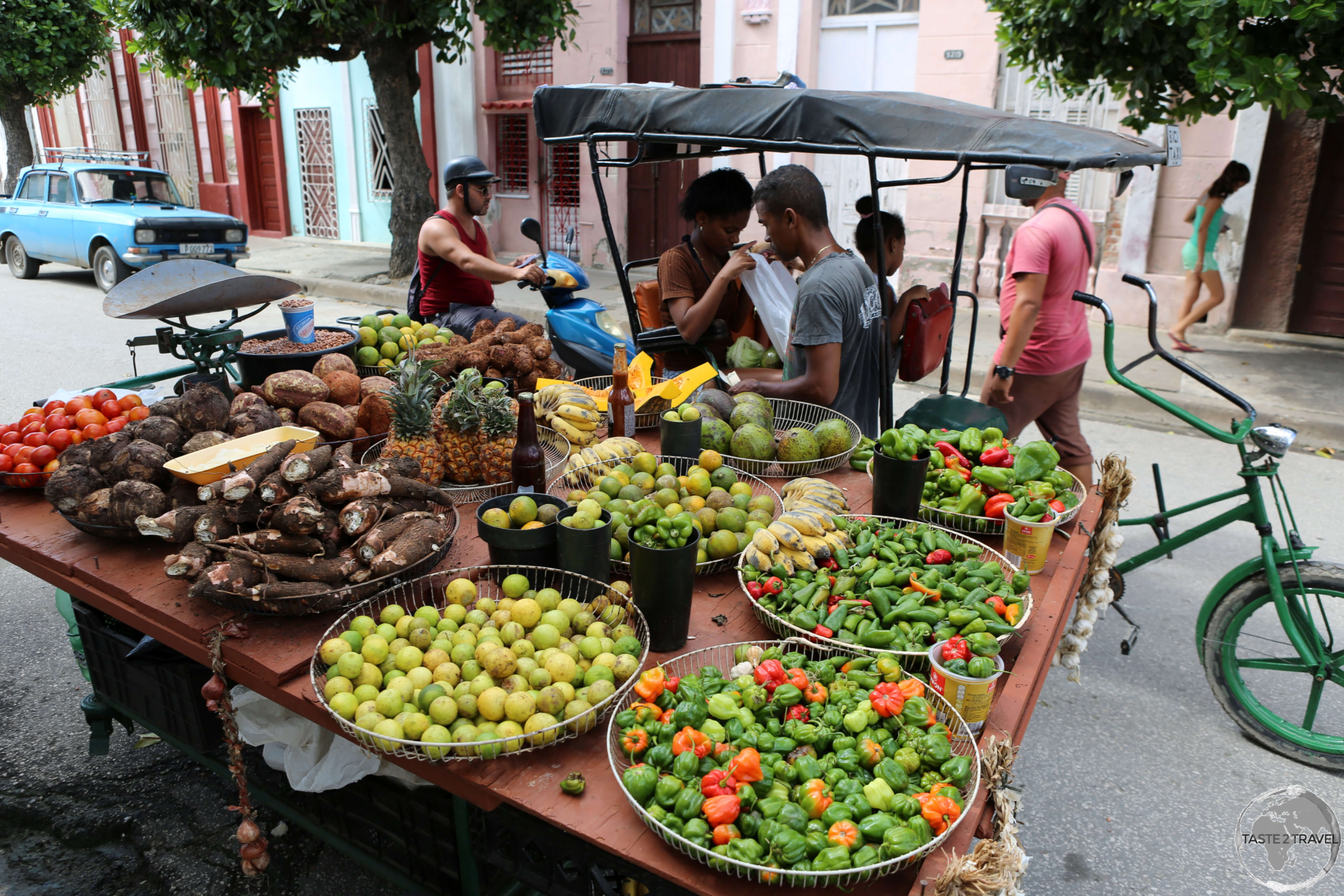 A family in Cienfuegos shopping from the comfort of a <i>Bicitaxi</i>.