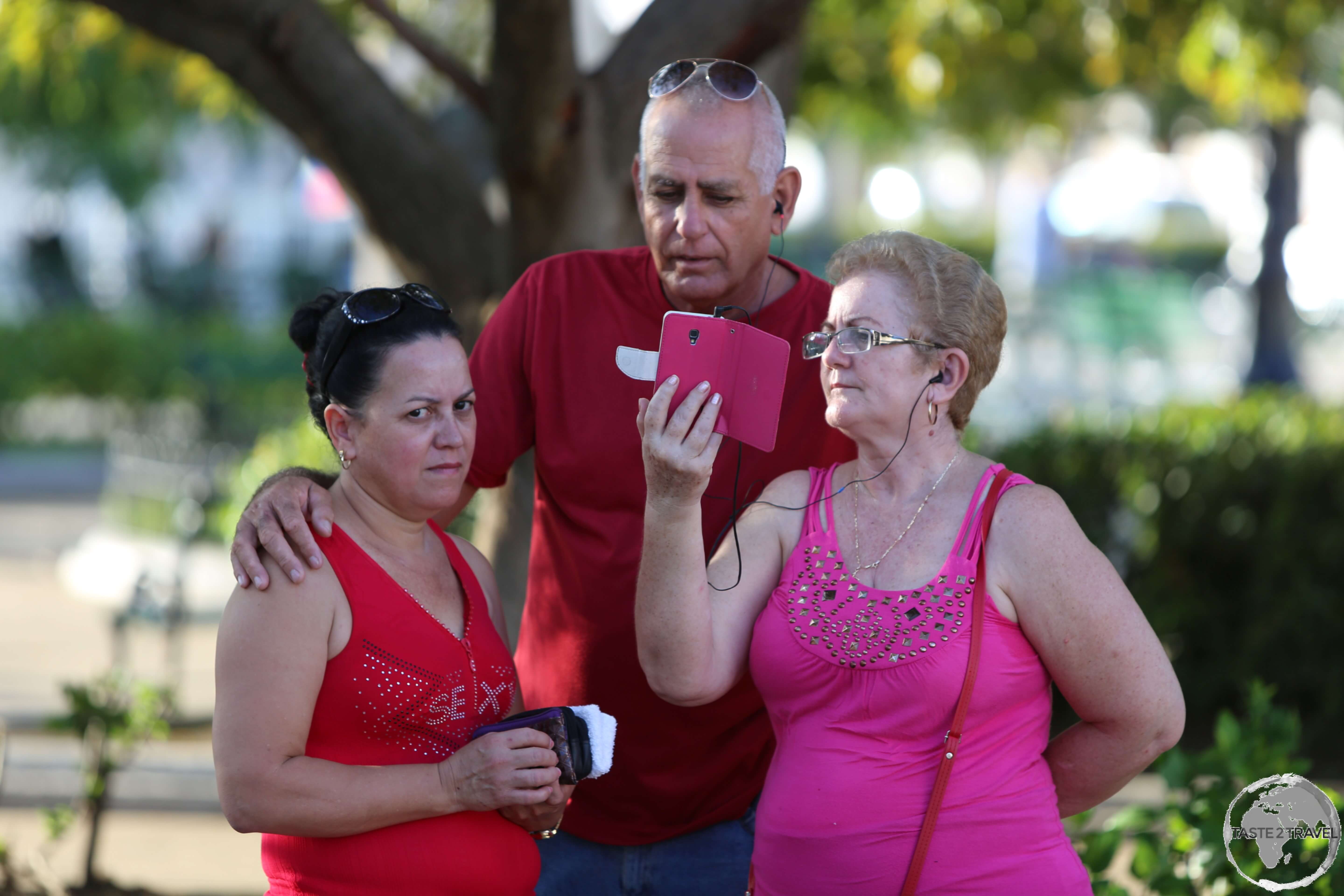 With almost two million Cubans living in the United States, Wi-Fi spots throughout the country, such as this one at <i>Plaza Jose Marti</i> in Cienfuegos, are always busy with families keeping in touch.