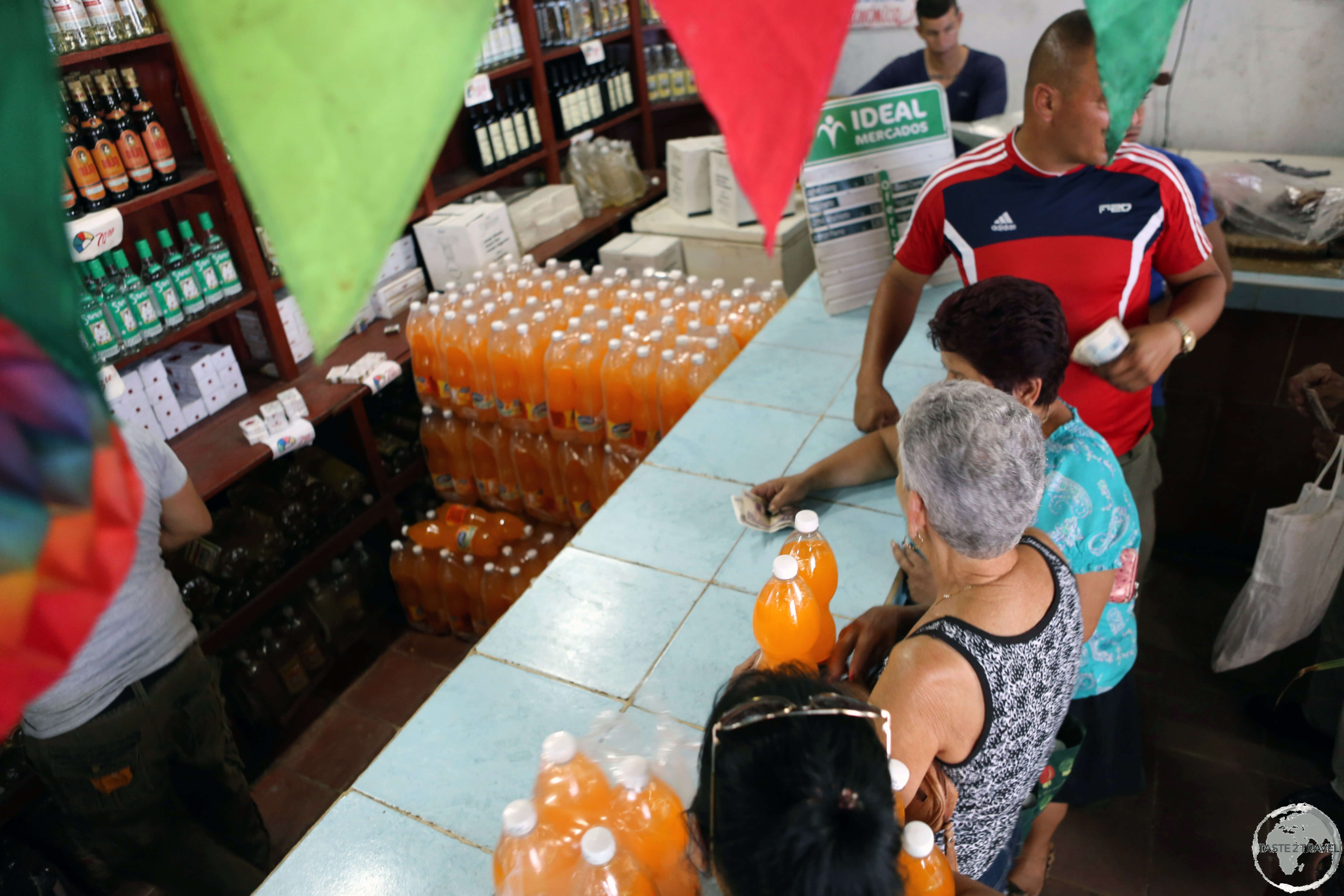 Locals, lining up to buy orange soda, which had just arrived at a shop in downtown Sancti Spiritus.