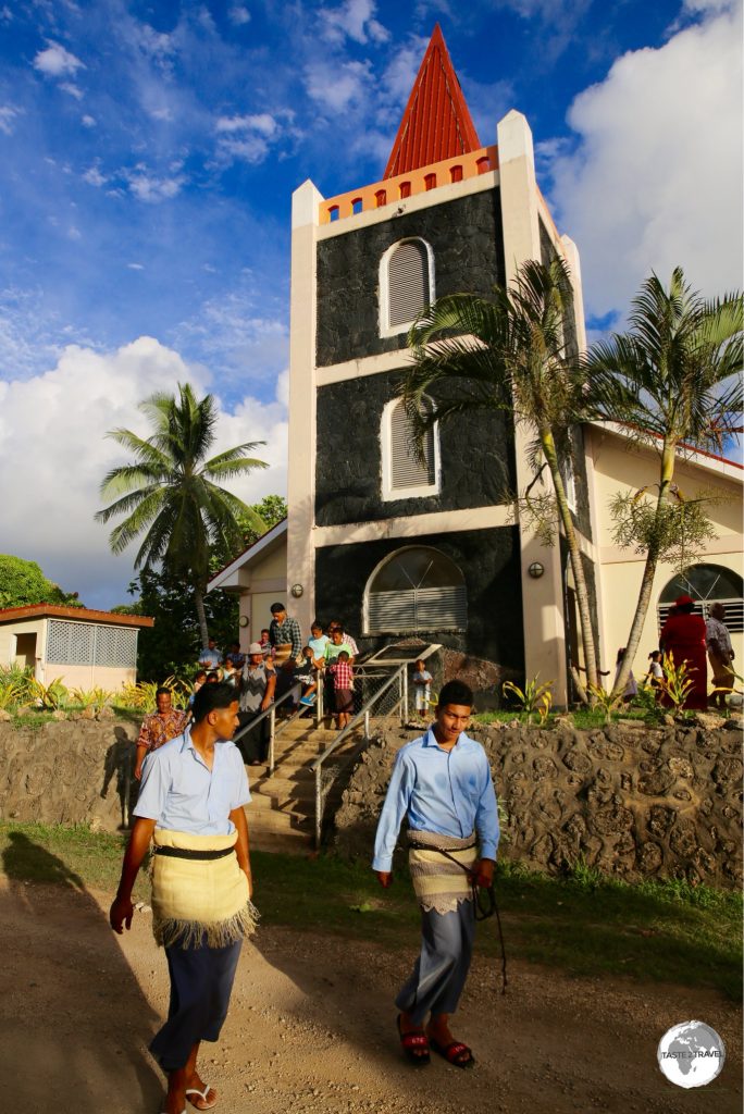 Worshipers in traditional dress leaving a church service on 'Eua.