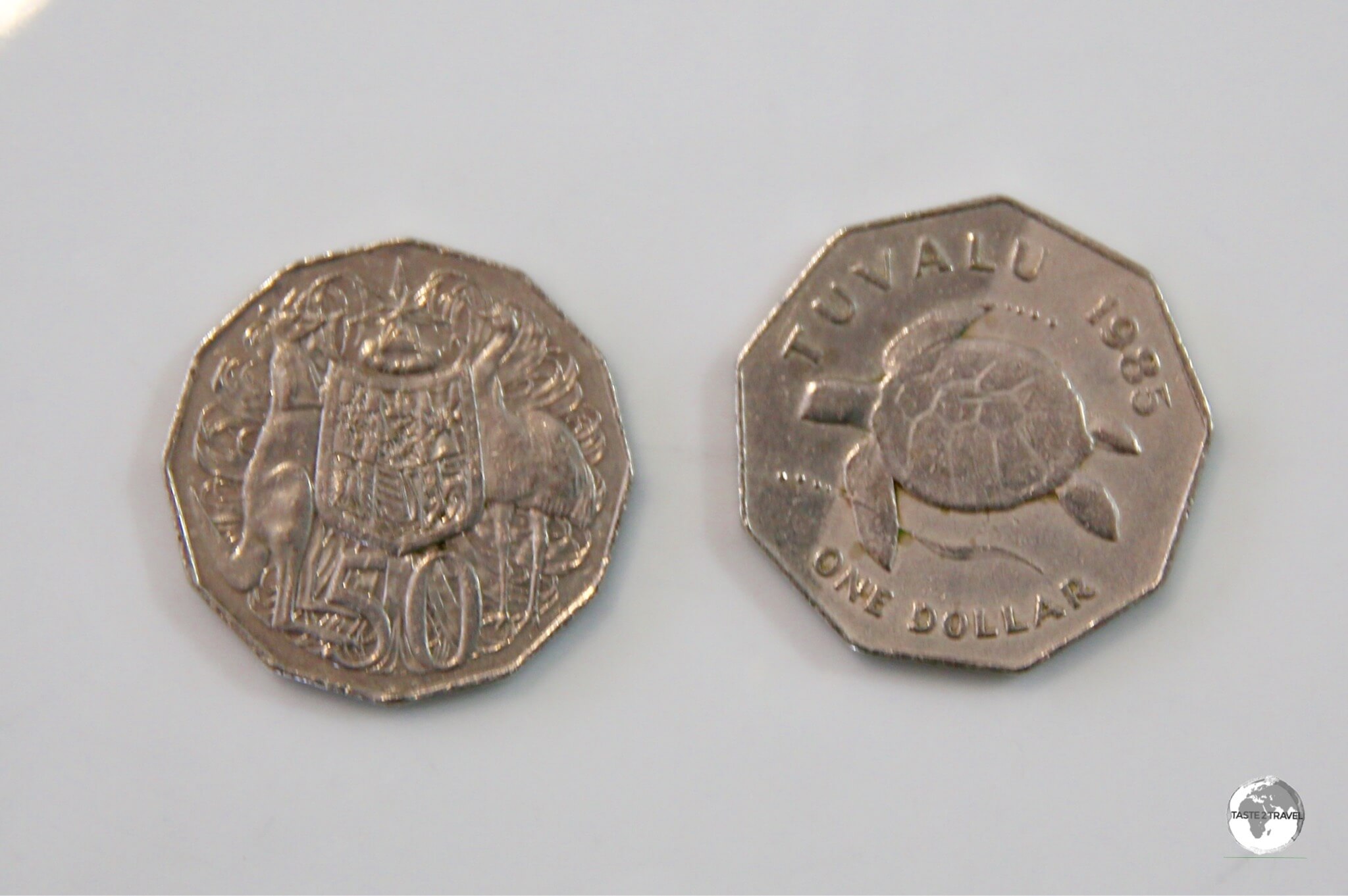 Although they look different when enlarge in this photo - when held in your hand, the Tuvalu $1 coin and Australian 50 cent coin are similar in shape and size.