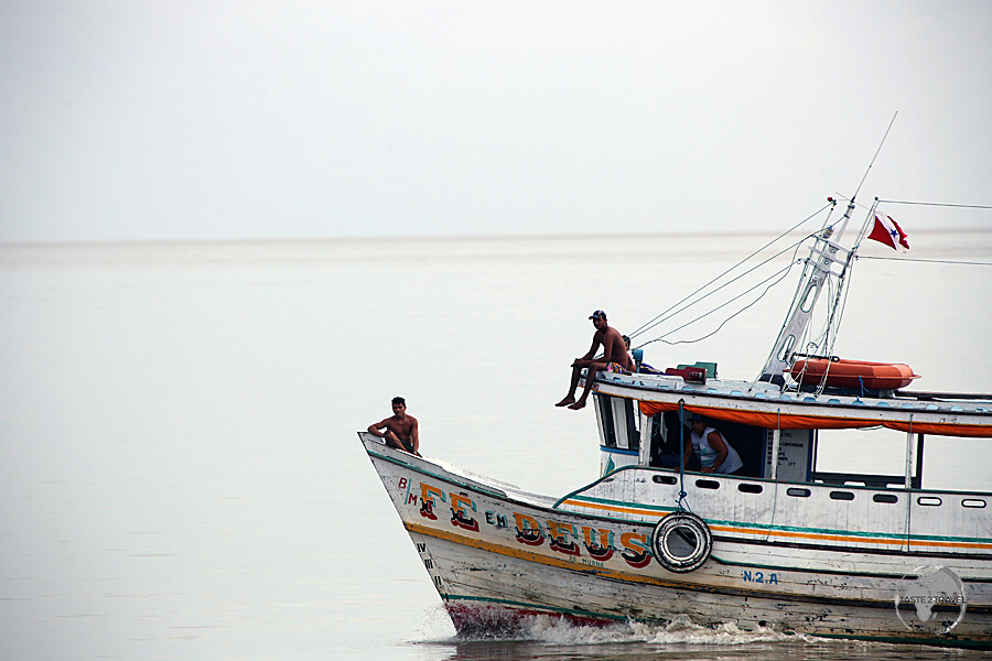 A boat cruising on the wide mouth of the Amazon River near Macapá.