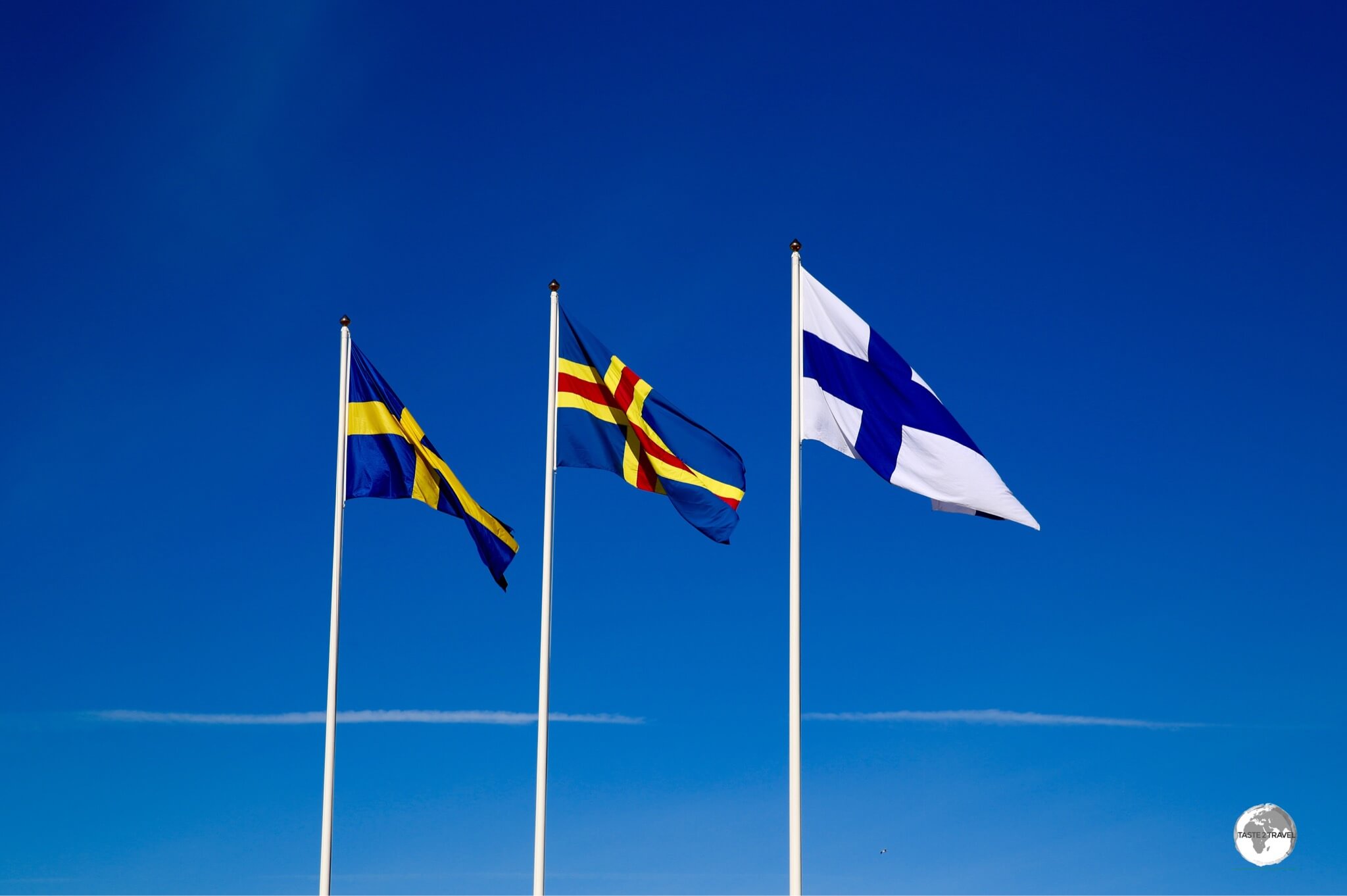 The flag of the Åland Islands (centre) surrounded by the flags of its all important, powerful neighbours - Sweden and Finland.