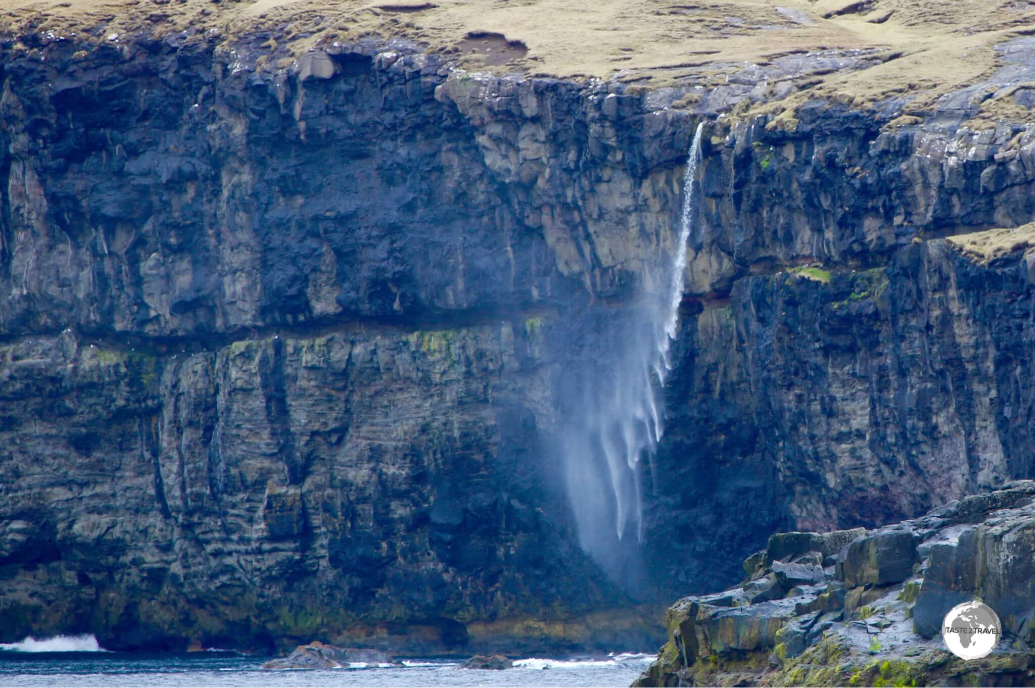 Plunging hundreds of metres before becoming mist, yet another dramatic waterfall on the remote north coast of Eysturoy, near the village of Eiði.