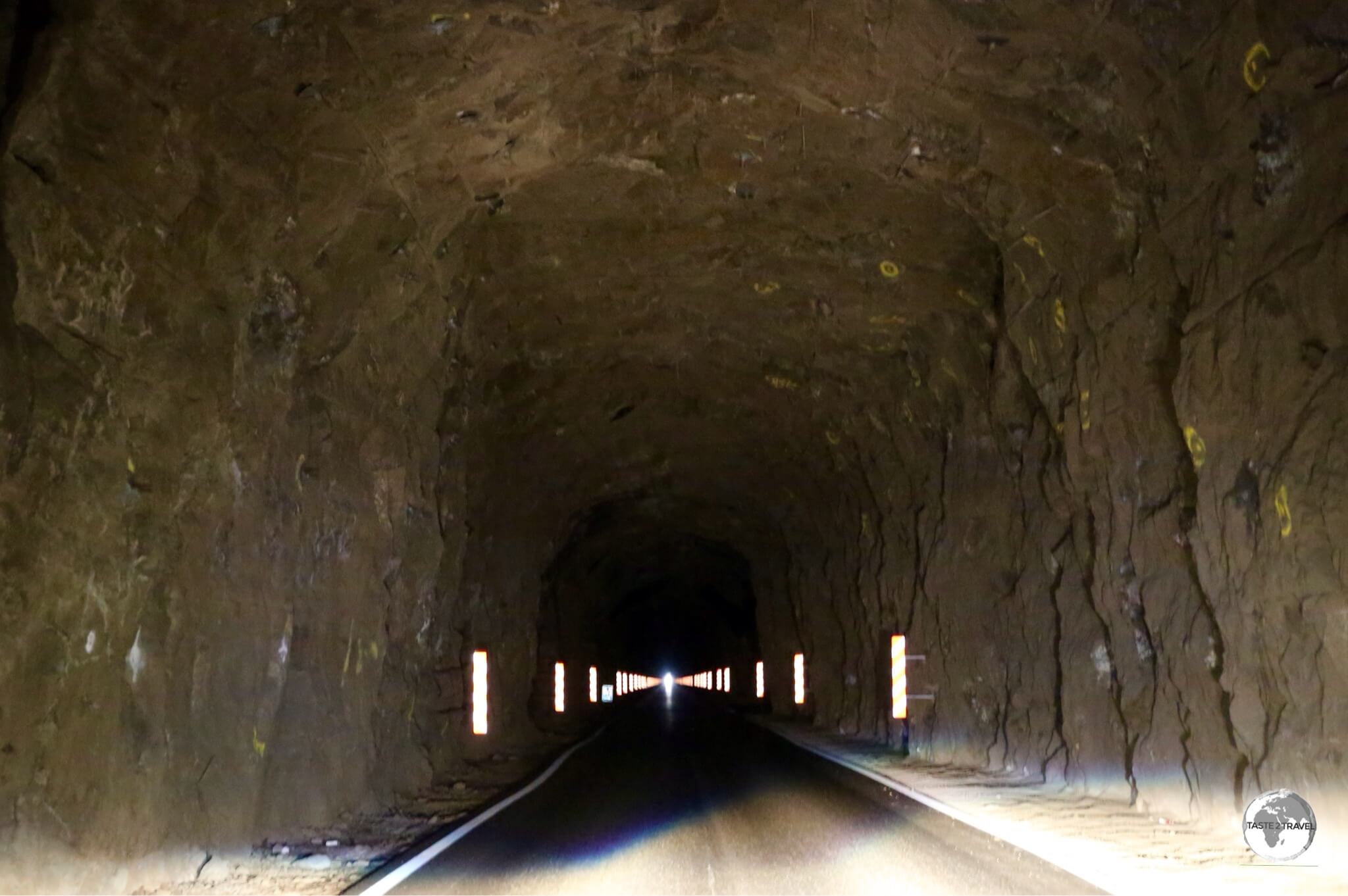 Driving through the one-lane, unlit, 3-km long Kunoy tunnel. Passing bays allow for oncoming traffic to pass.