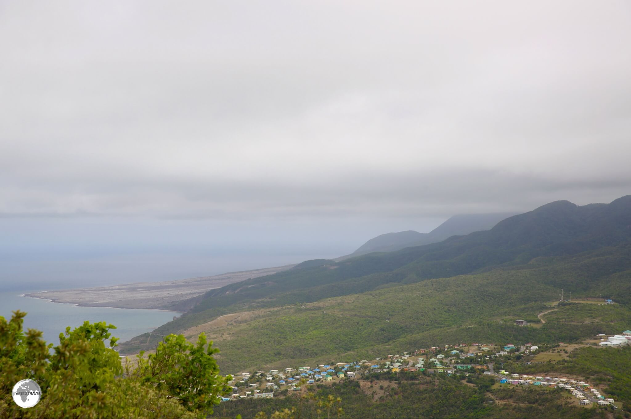 The panoramic view south from Silver Hills with the new settlement of 'Lookout' in the foreground and the remnants of a pyroclastic flow in the background.