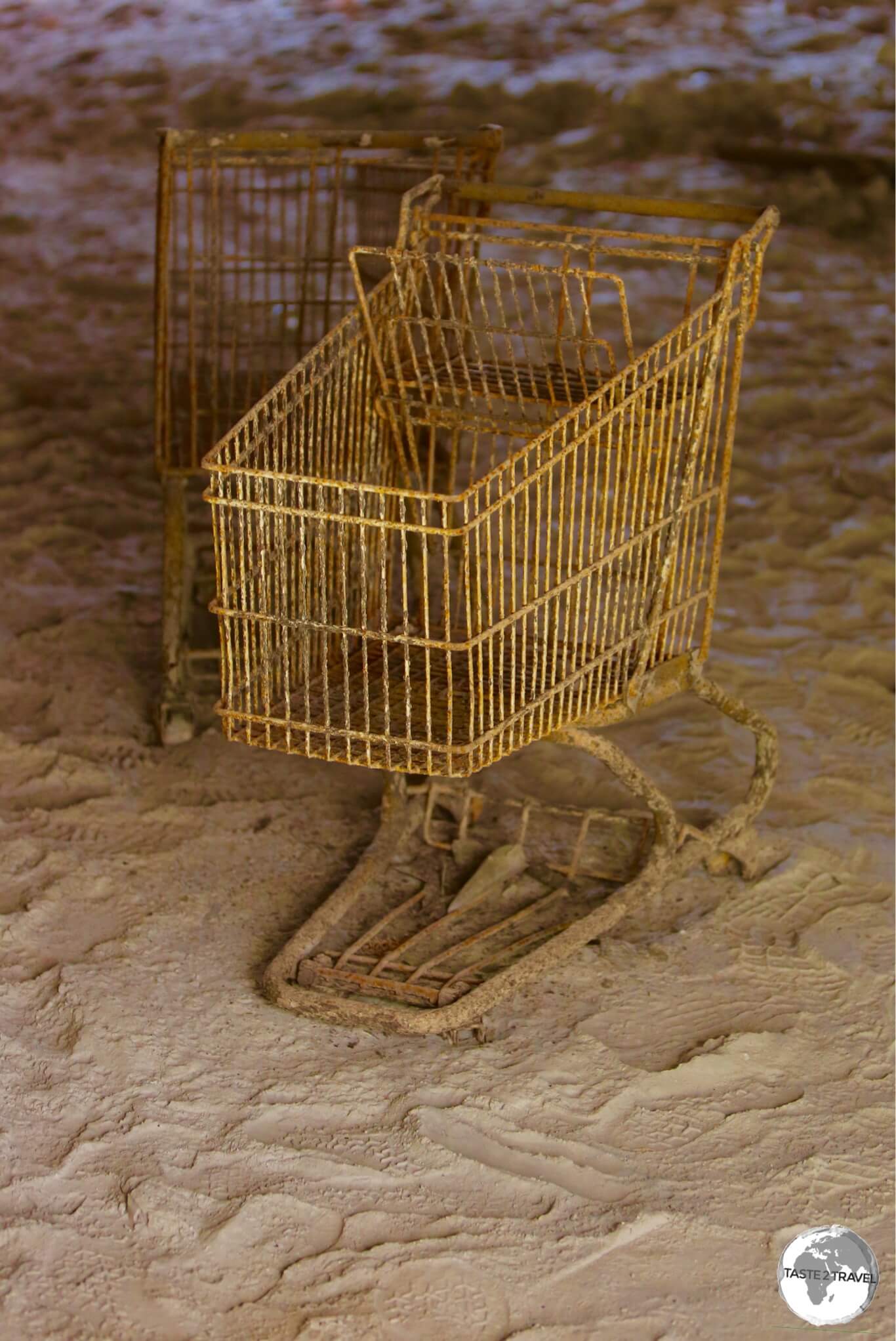 Trolleys, covered in volcano ash, remain where they were left in the former Angelo's supermarket in Plymouth.