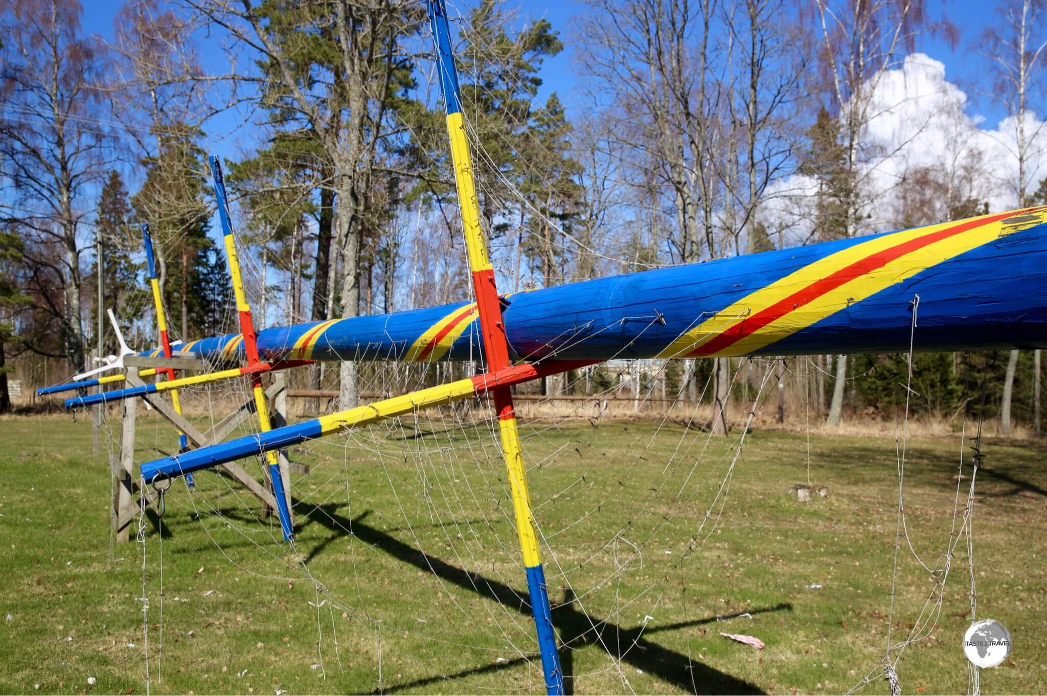 A Maypole painted in the colours of the Åland flag being prepared for the upcoming mid-summer festivities.