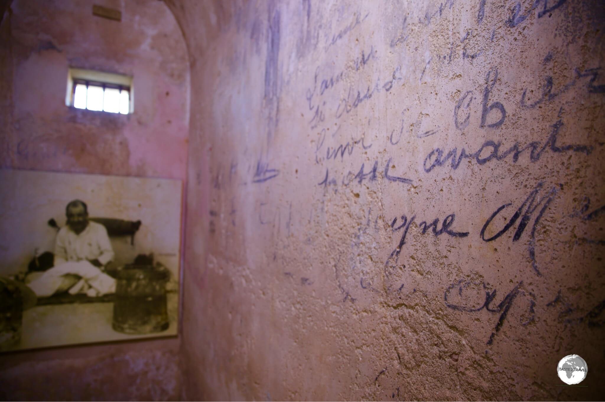 Convict graffiti decorates the wall of a cell at Fort Téremba.