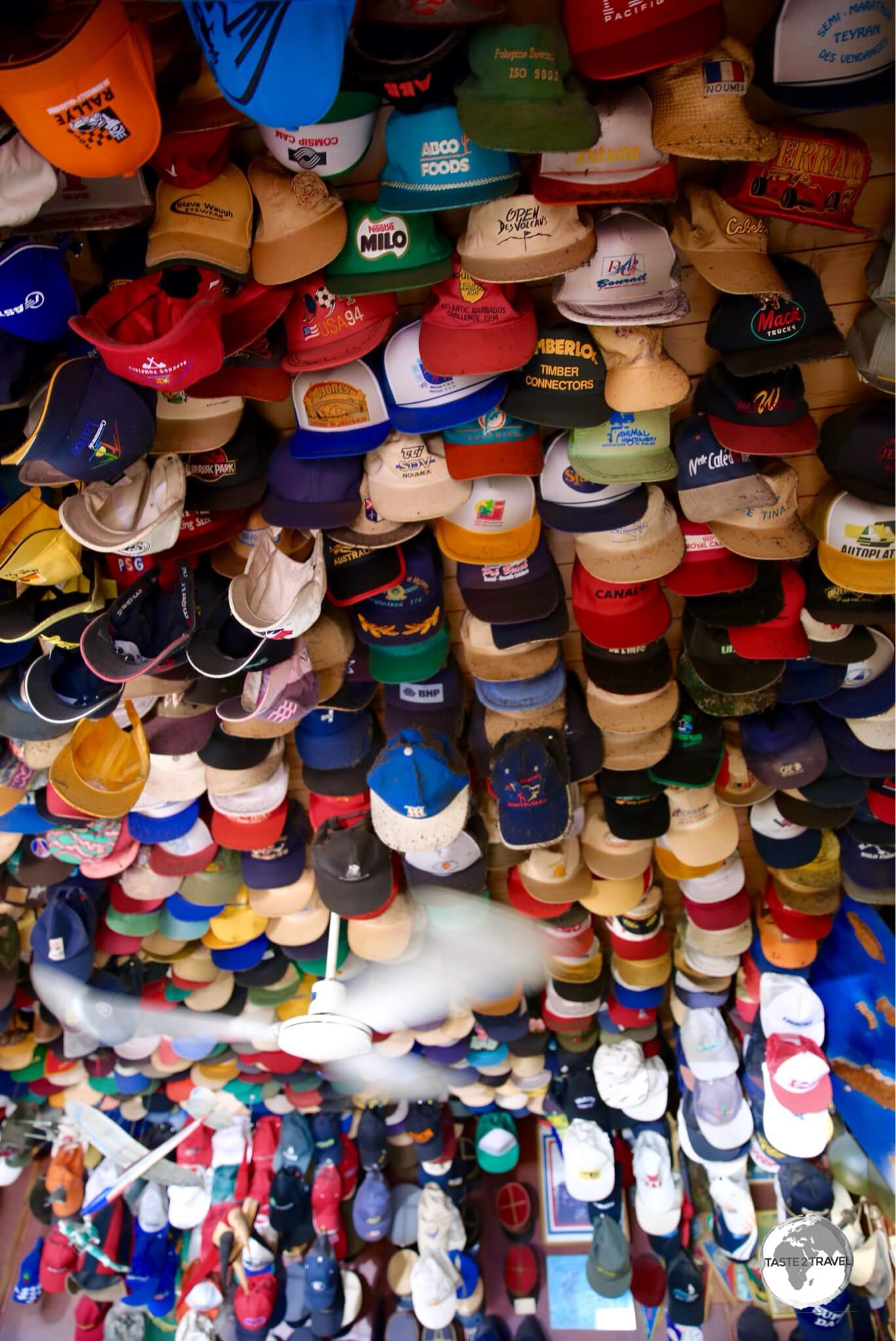 Baseball caps line the ceiling of the bar at the Hotel Banu in La Foa. 