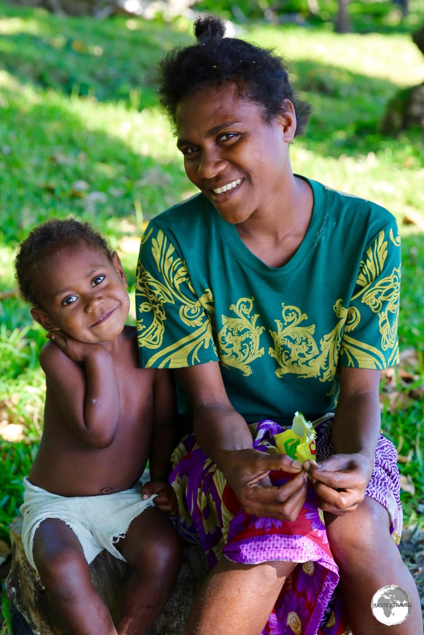 Mother and son relaxing on the beach on Tanna.