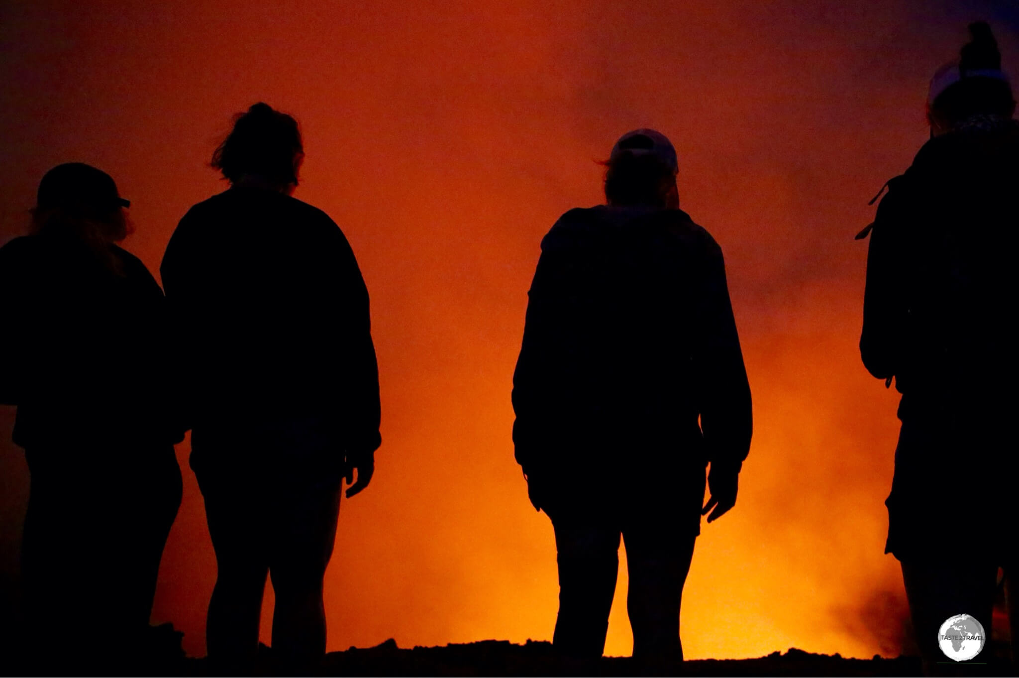 Fellow visitors, illuminated by the fiery glow from Mount Yasur volcano.