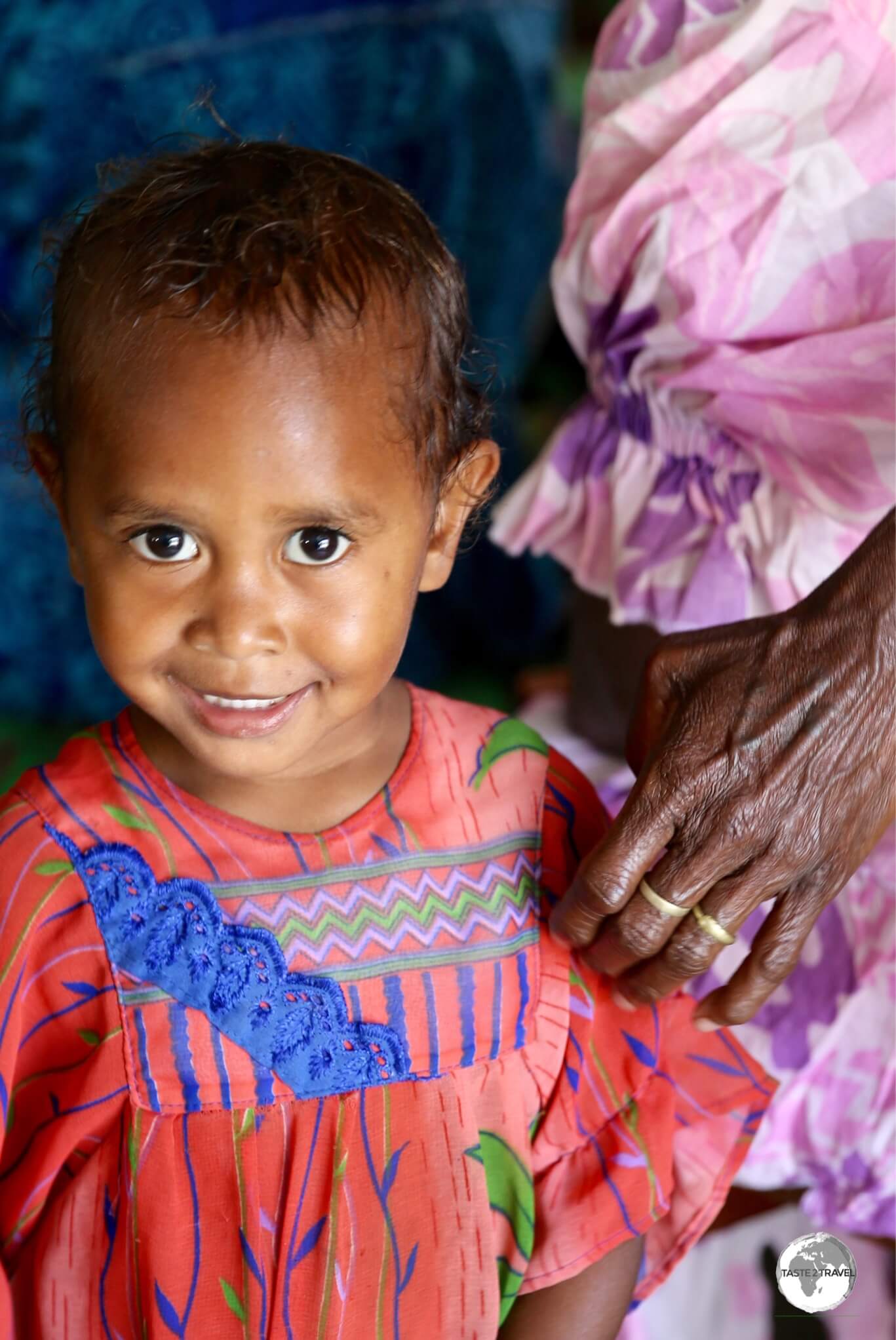 A smiley young girl, distracted in a church service on Tanna island.