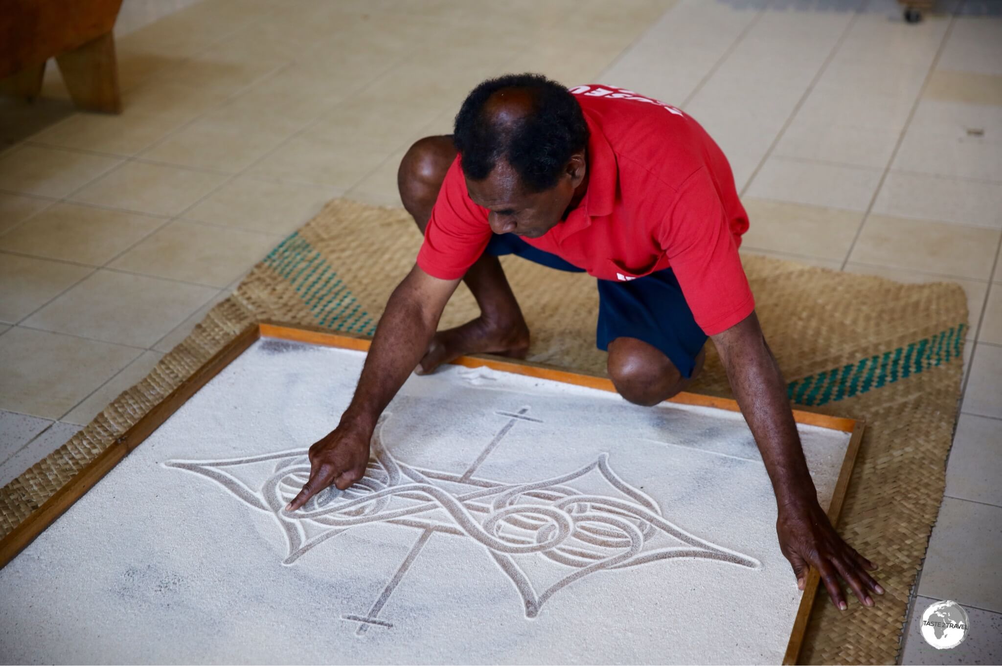 Edgar Hinge of the National Museum of Vanuatu, telling a story using the ancient art of Sand-drawing.