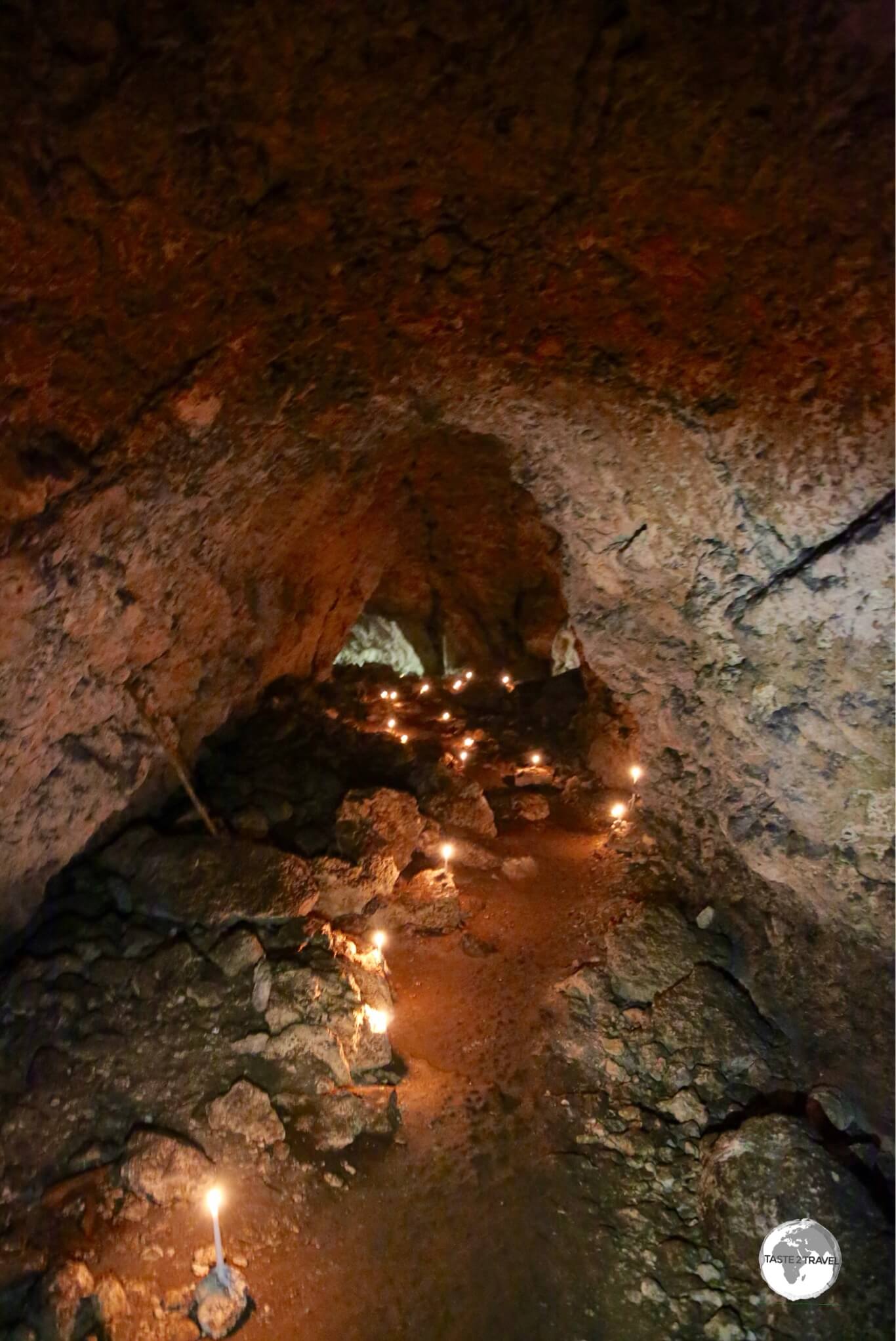 A large cave on Lelepa island is illuminated by candlelight.