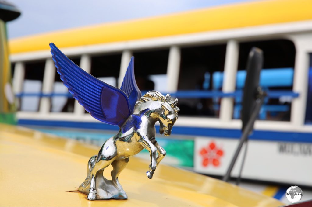 A shiny hood ornament on a Samoan bus.