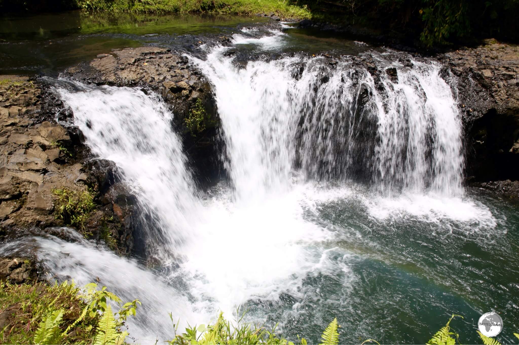 Surrounded by lush vegetation, the Togitogiga Waterfalls are a popular swimming hole. 