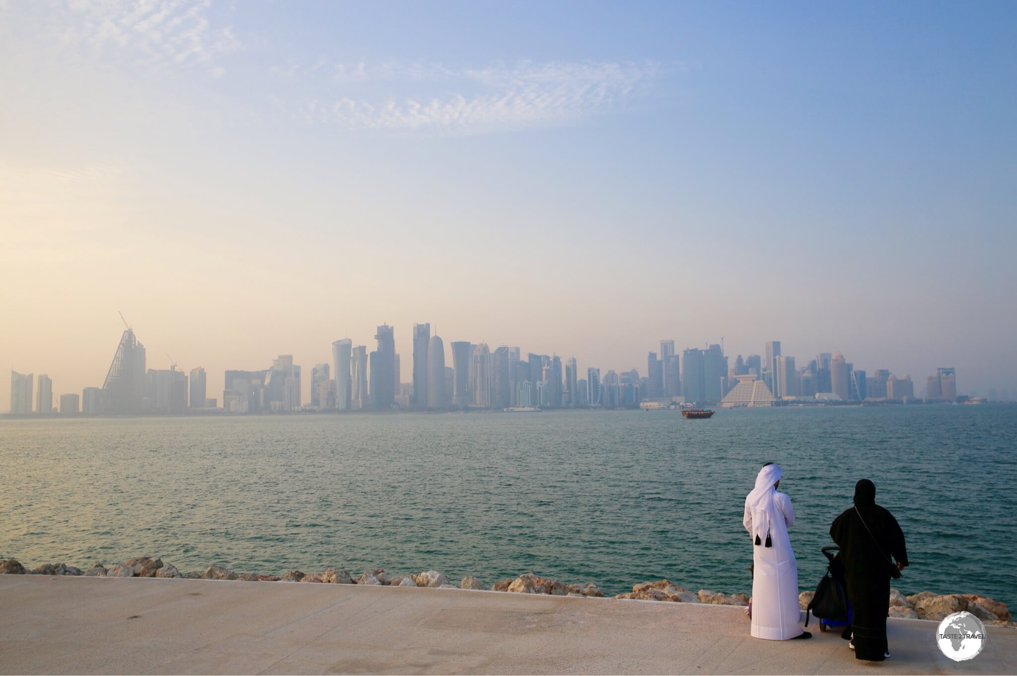 A Qatari couple admiring the Doha skyline from MIA park. 