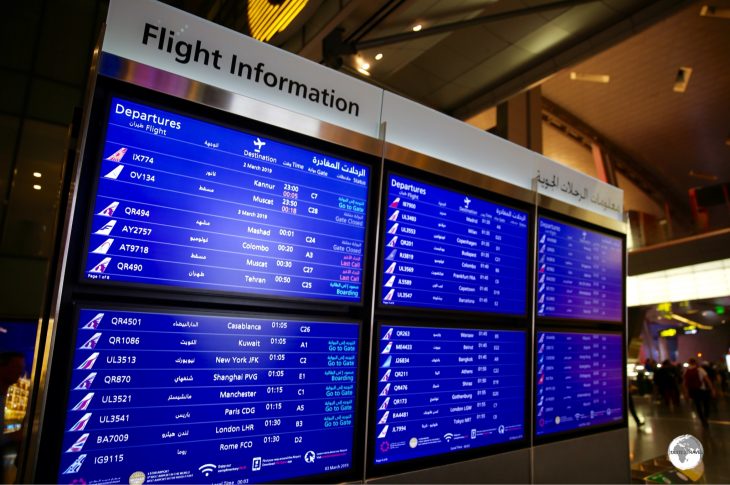 Departure boards at Hamid International Airport.