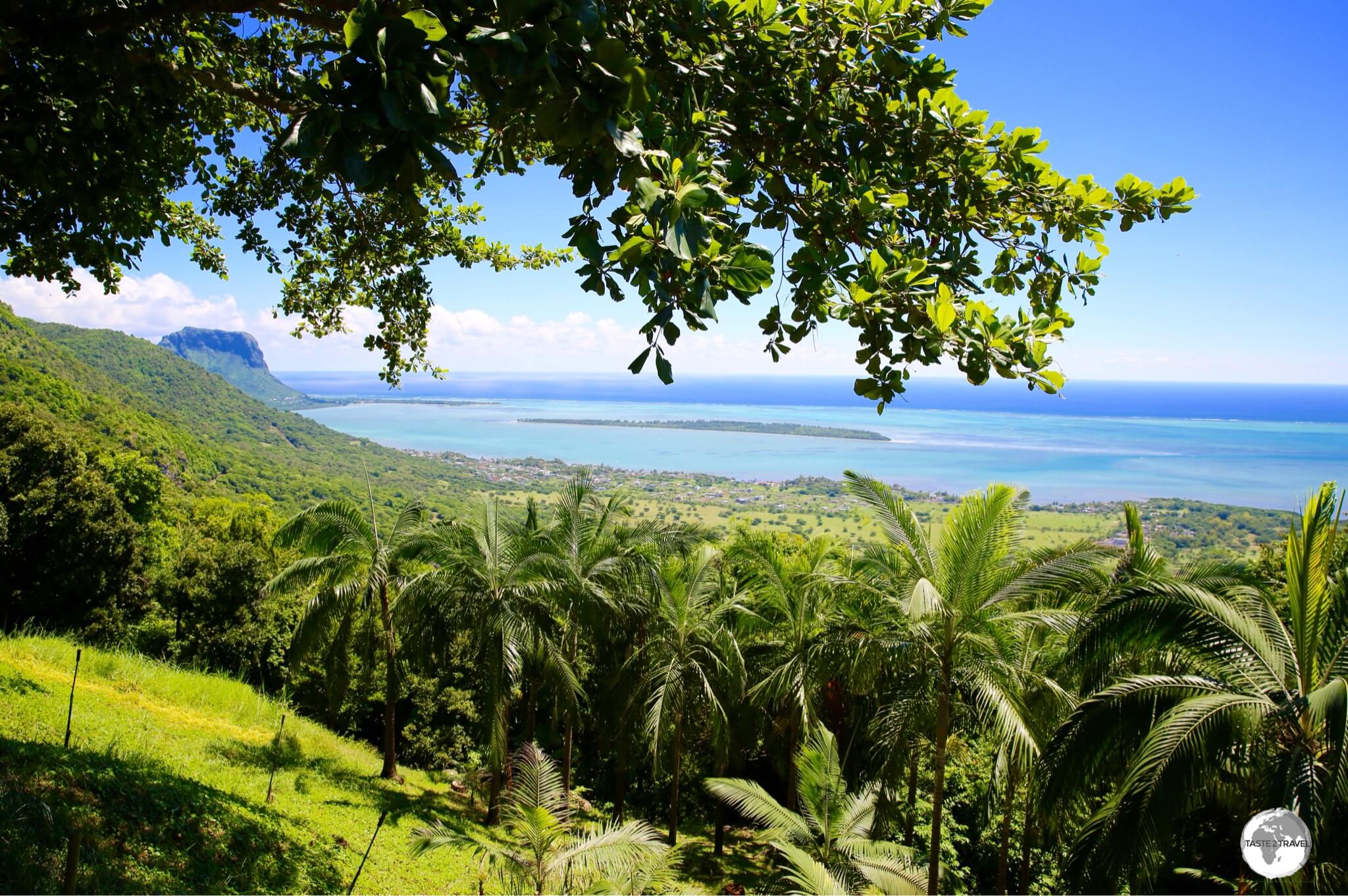 The view from Chamarel over the southwest coast, including Ile aux Benitiers and Le Morne Brabant.