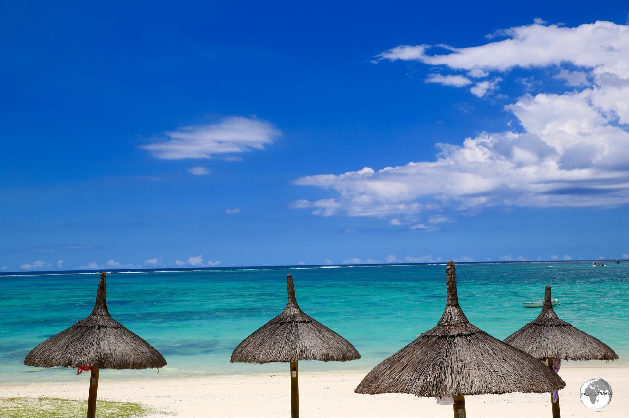 Thatched umbrellas provide shade on the east coast beach of Belle Mare.