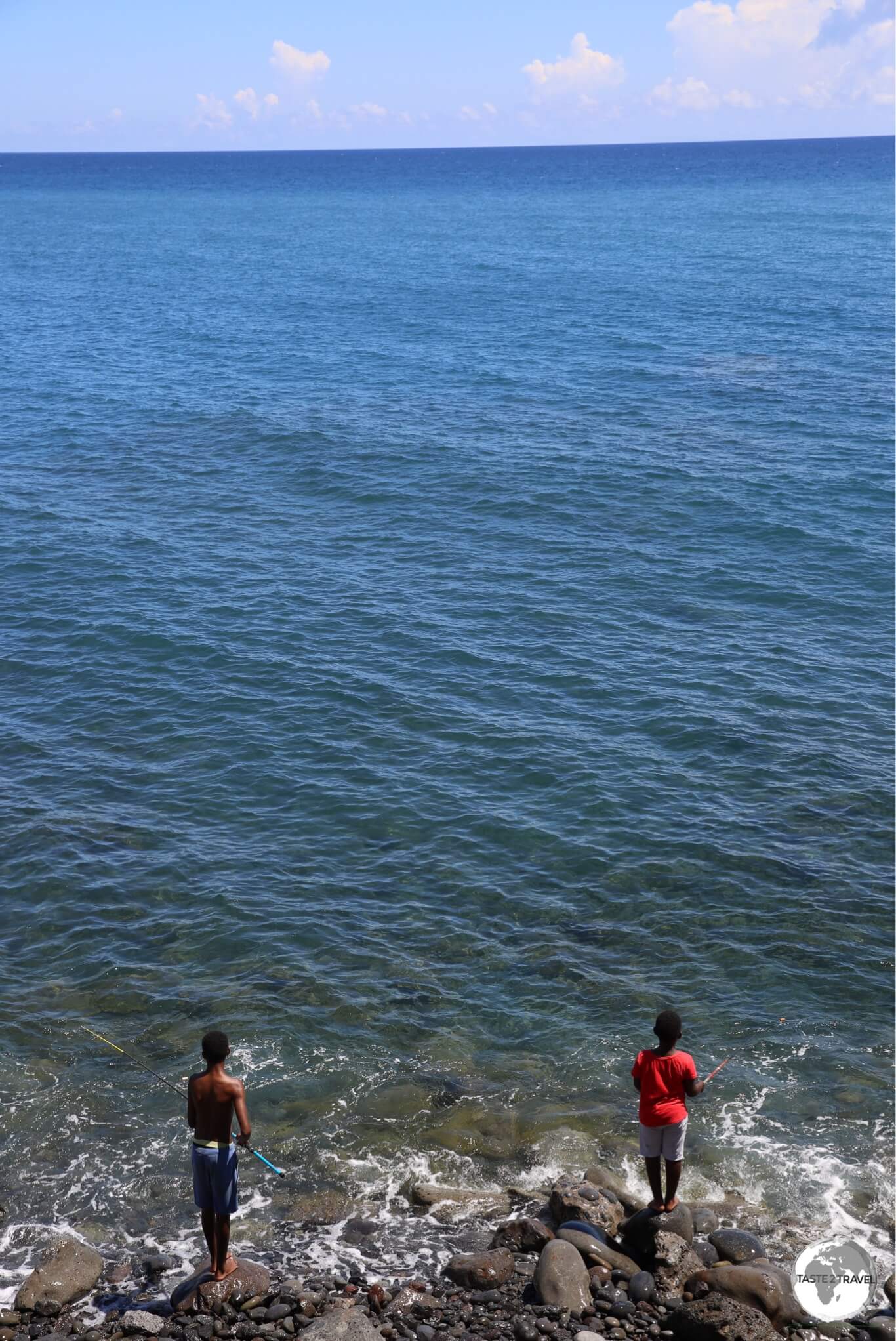 The clean waters of the Indian ocean provide an ideal fishing ground for two local boys, seen here at Le Barachois. 