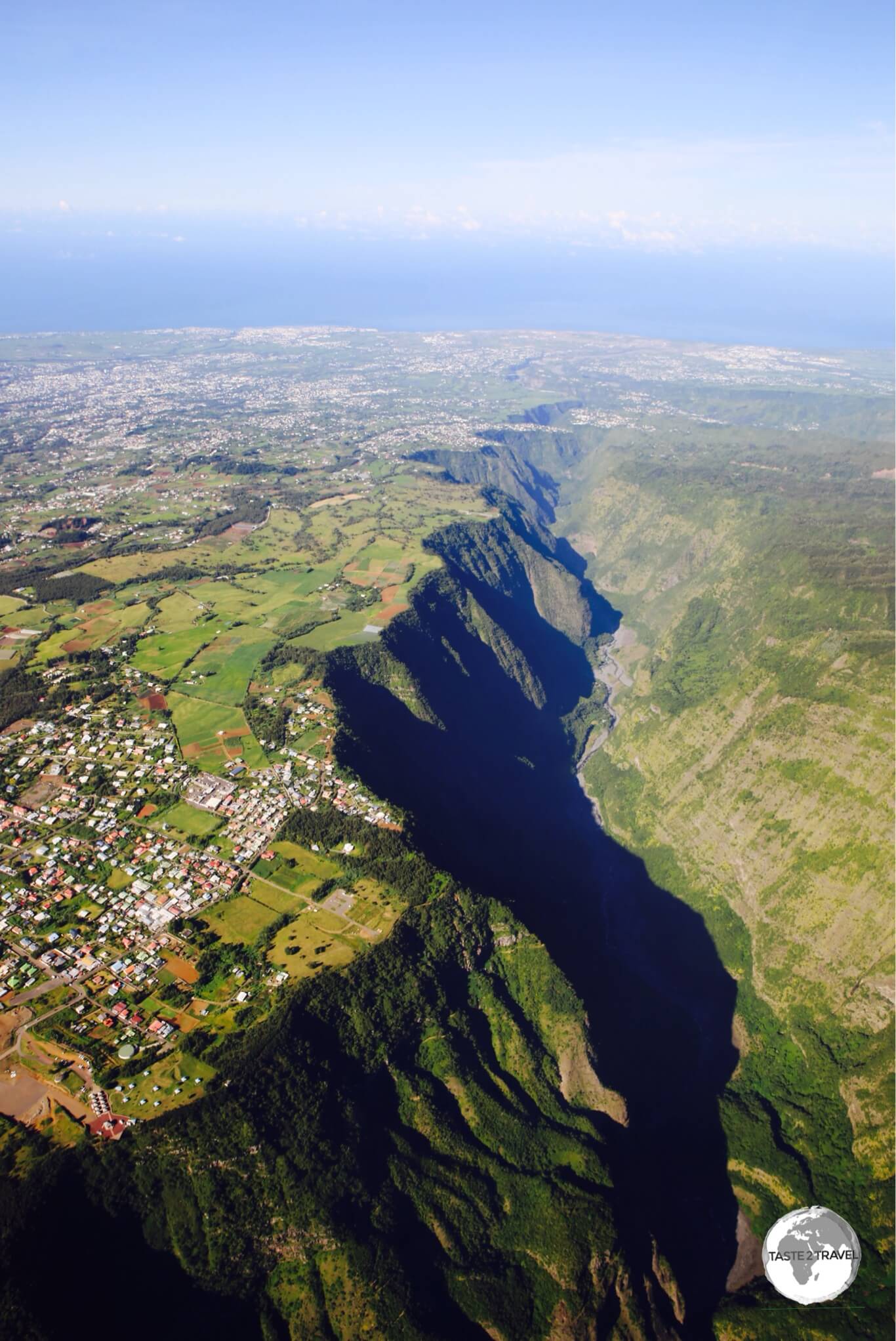 'Living on the Edge' - houses built close to the edge of a deep gorge, as seen from my helicopter flight over Réunion Island.