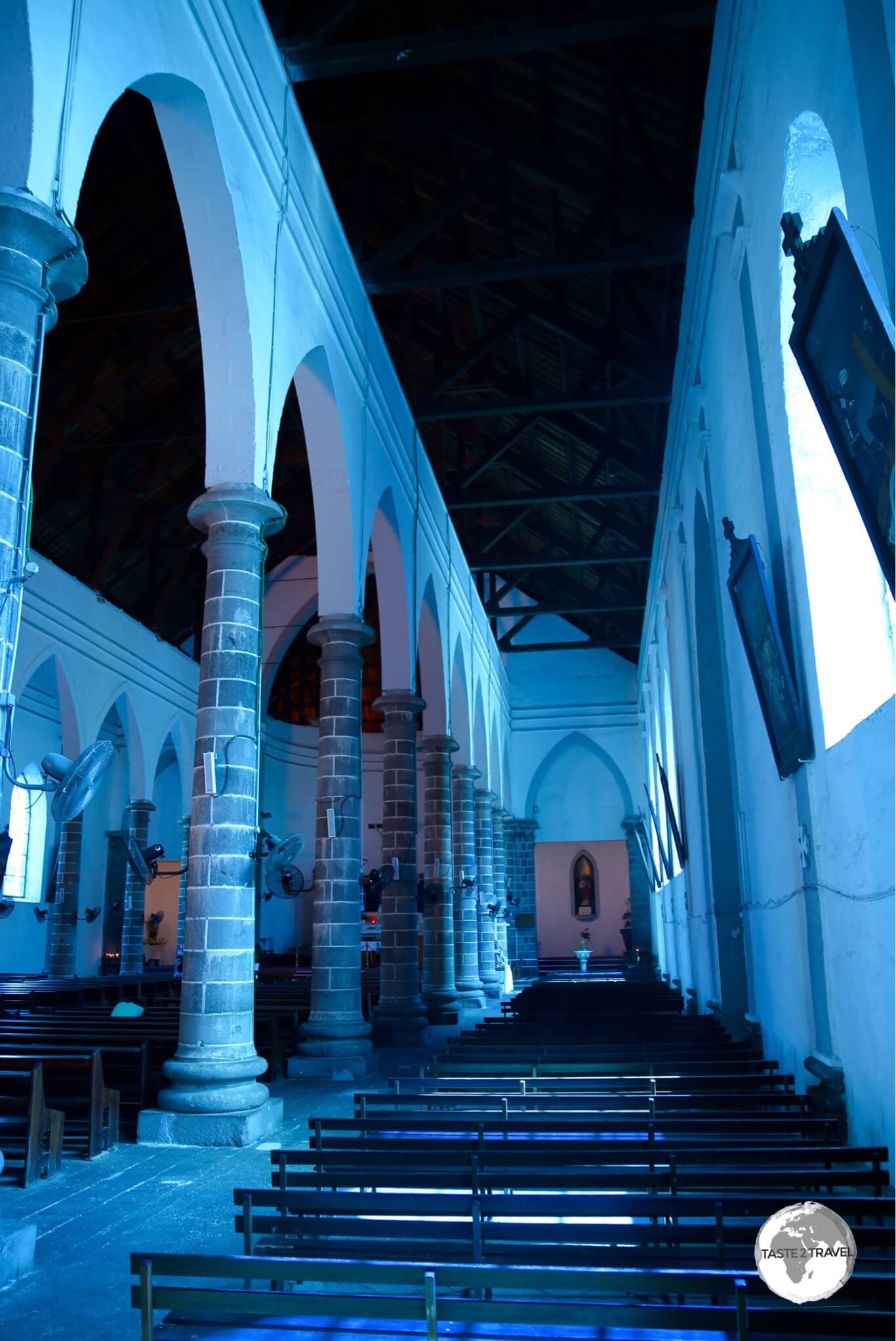 Strangely relaxing, the interior of the <i>Eglise de St Louis</i> is bathed in a soft, blue light. 