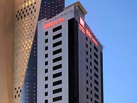 The Ibis Sharq Hotel is dwarfed by Al Hamra tower.