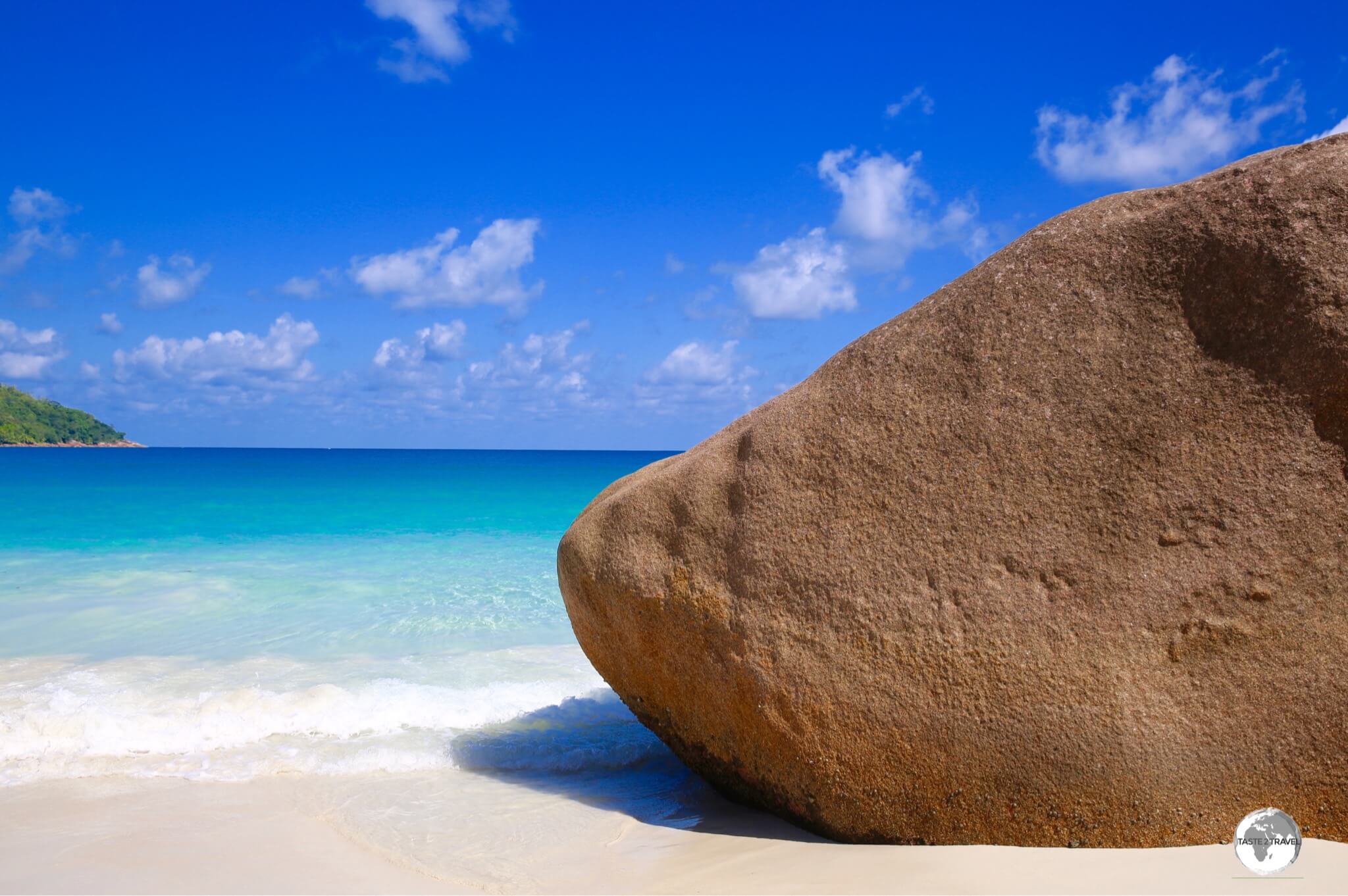 The many terracotta-coloured, granite boulders provide a stark contrast against the turquoise waters and blue skies of the Seychelles, such as this one on Anse Lazio, Praslin Island.